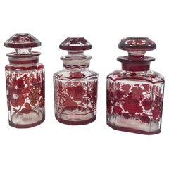 Elegant Set of Three 1940s Red Glass Bottles with Applied Relief Decoration