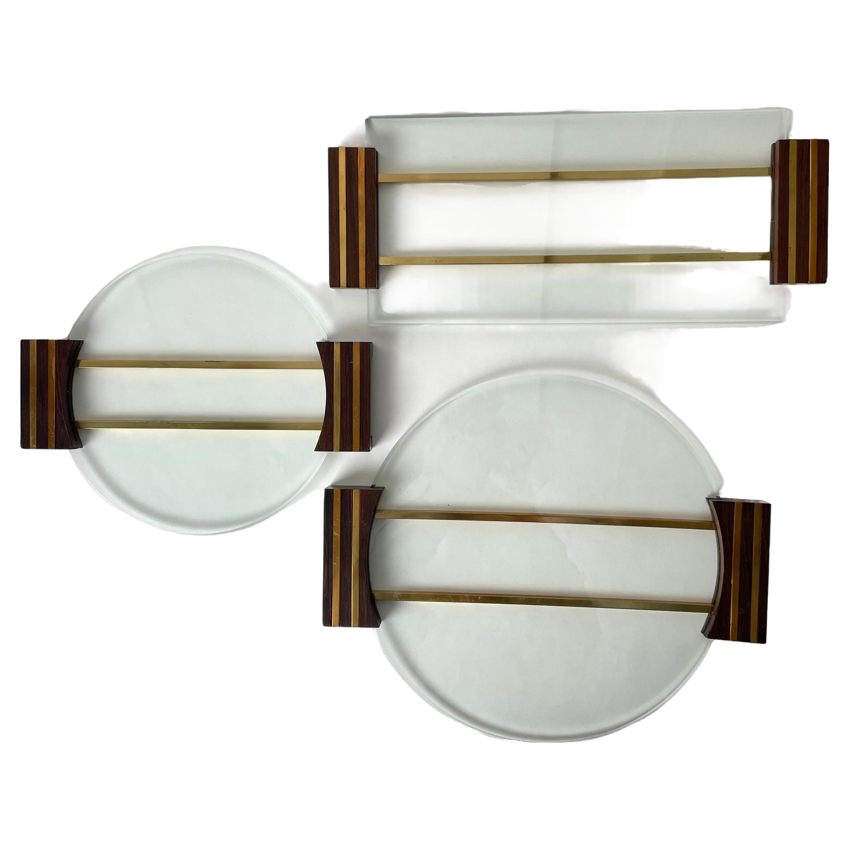 Elegant set of three Cheese Trays from the Mid-20th Century. Cool design in glass, brass and wood.

The cheese trays have the following dimensions:
31,5*27*2 cm
25,5*21*2 cm
35*15*2 cm

Wear consistent with age and use 
