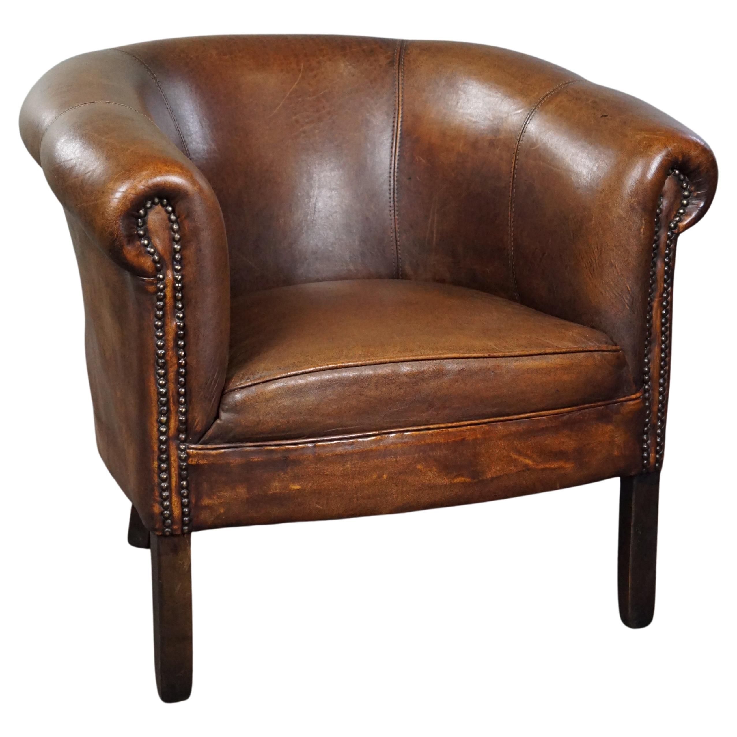 Elegant sheepskin club armchair in a subtle size