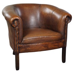 Elegant sheepskin club armchair in a subtle size