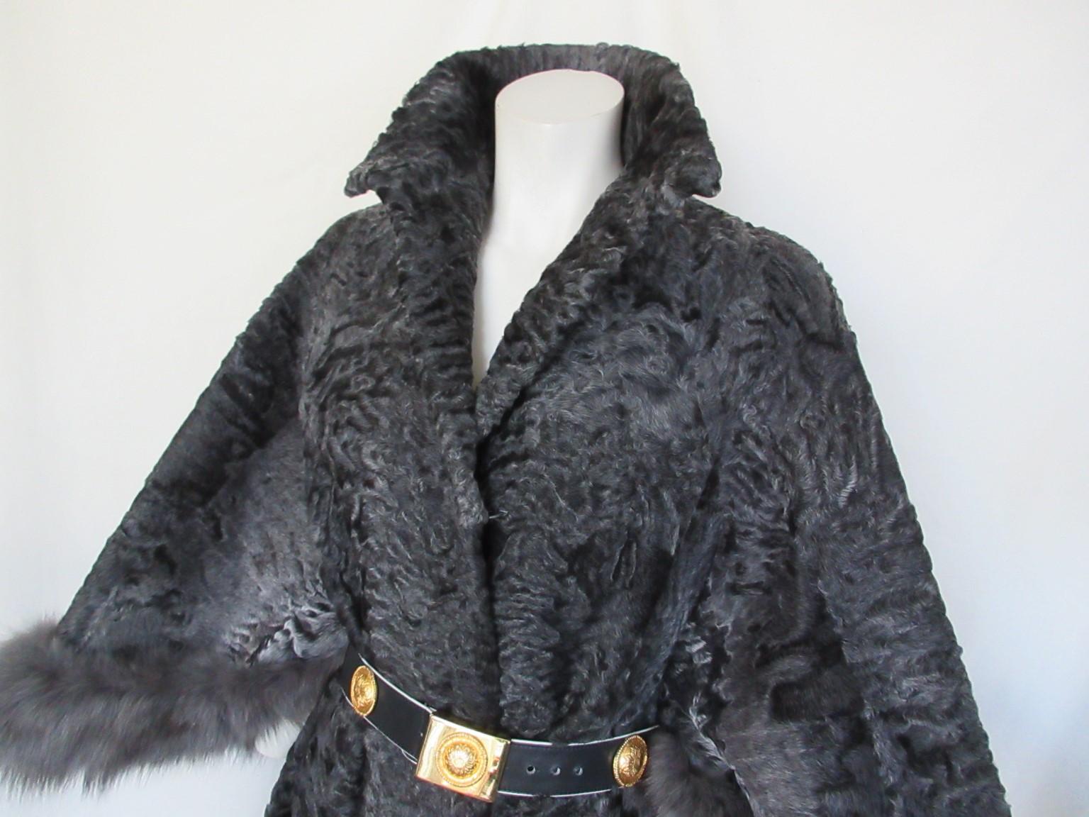This vintage astrakhan/persian lamb fur coat trimmed with grey fox fur cuffs 
Rare to find model

We offer more exclusive fur, view our frontstore 

Details:
The coat has 3 closing hooks ,
Fully lined
3/4 sleeves 
The coat is a wide model and is