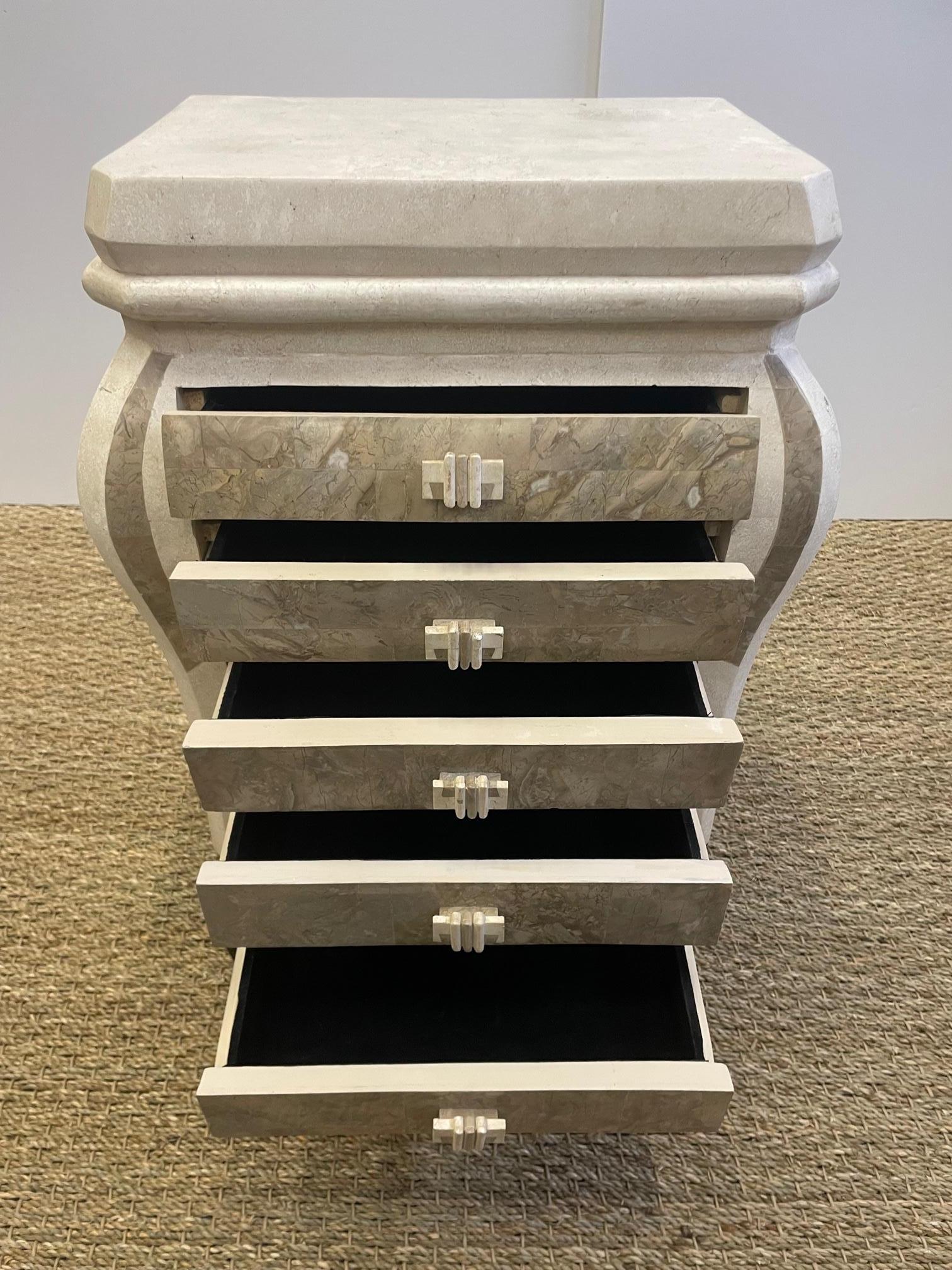 Elegant small treasure chest of drawers made of cream and taupe tessellated stone, having 5 black velvet lined drawers and a gorgeous leaf motif oil bronze rubbed iron base.