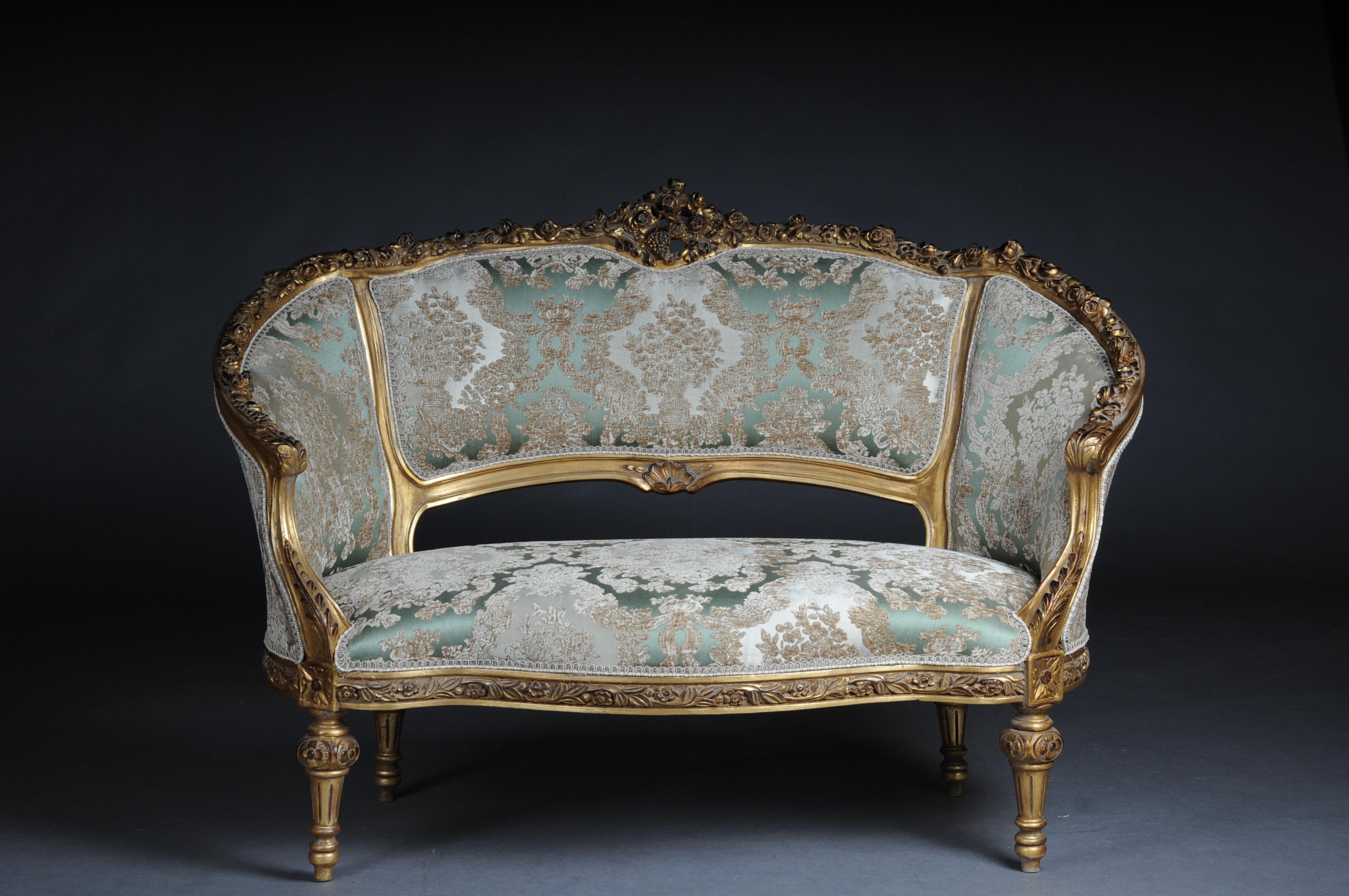 Elegant sofa, canapé, couch in Rococo or Louis XV style.

Solid beech wood, carved and gilded. Rising backrest framing with openwork rocaille crowning. Appropriately curved frame with richly carved foliage. Slightly curved frame on straight legs.