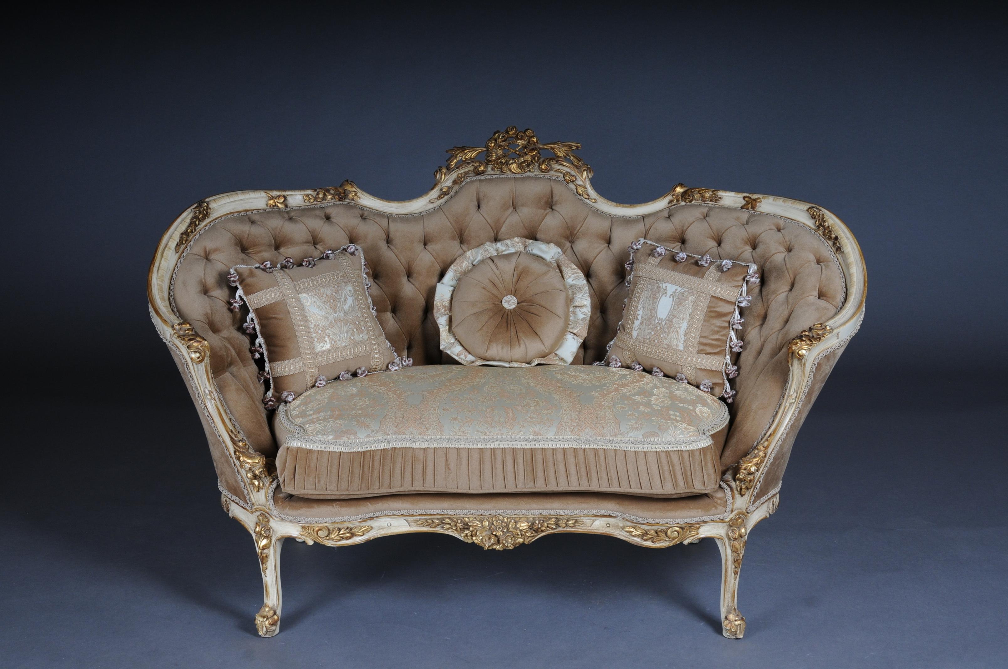 Elegant sofa, couch, Canapé in Rococo or Louis XV Style.

Solid beech wood, carved and gilded. Rising backrest framing with openwork rocaille crowning. Appropriately curved frame with richly carved foliage. Slightly curved frame on straight legs.