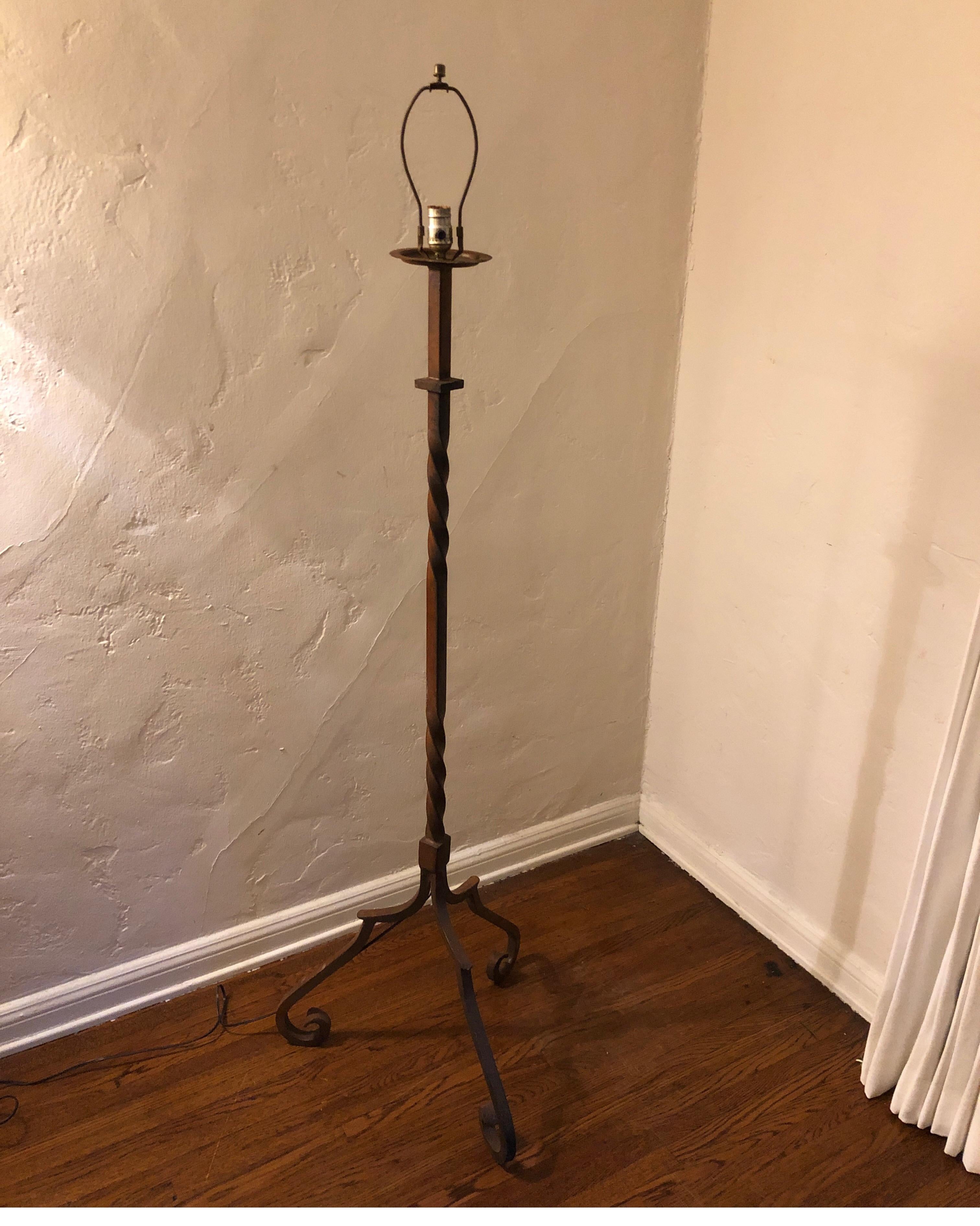 Heavy hand gilded wrought iron twisted Spanish floor lamp. 
Stands on tripod curved legs.

Shade shown for display only and not included.