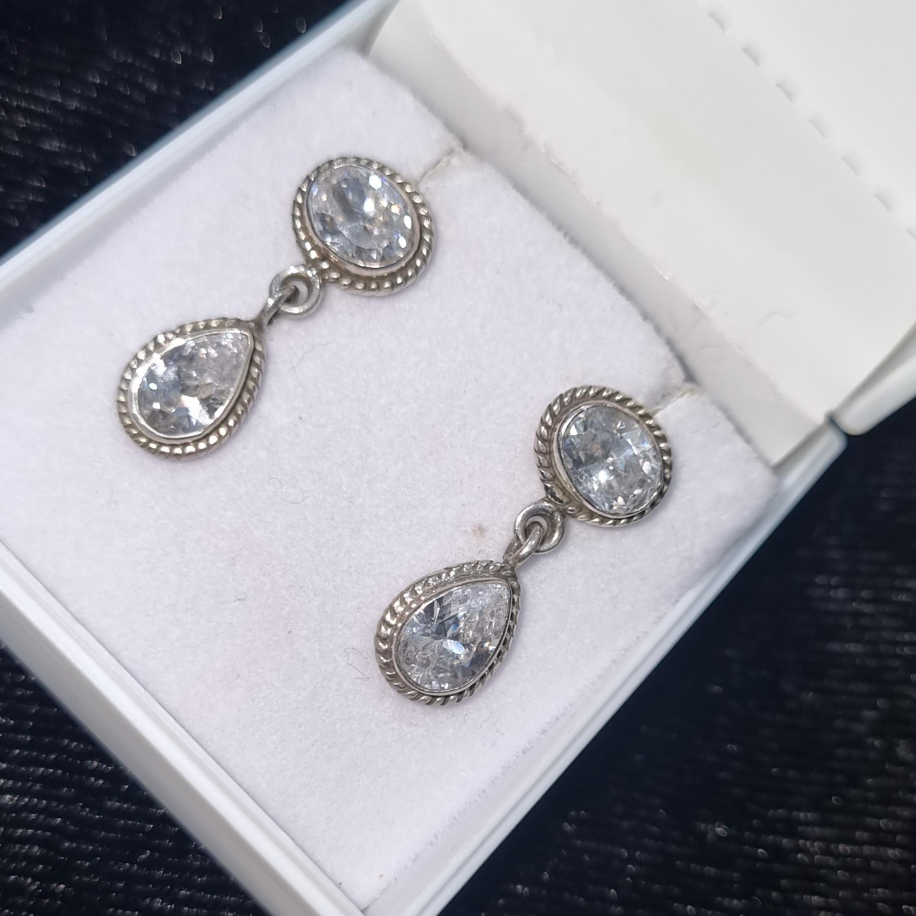 Elevate your style with our exquisite Sterling Silver Stud Earrings featuring a stunning combination of oval and drop-cut cubic zirconia diamonds. Crafted with precision and elegance, these earrings are a timeless addition to your jewelry