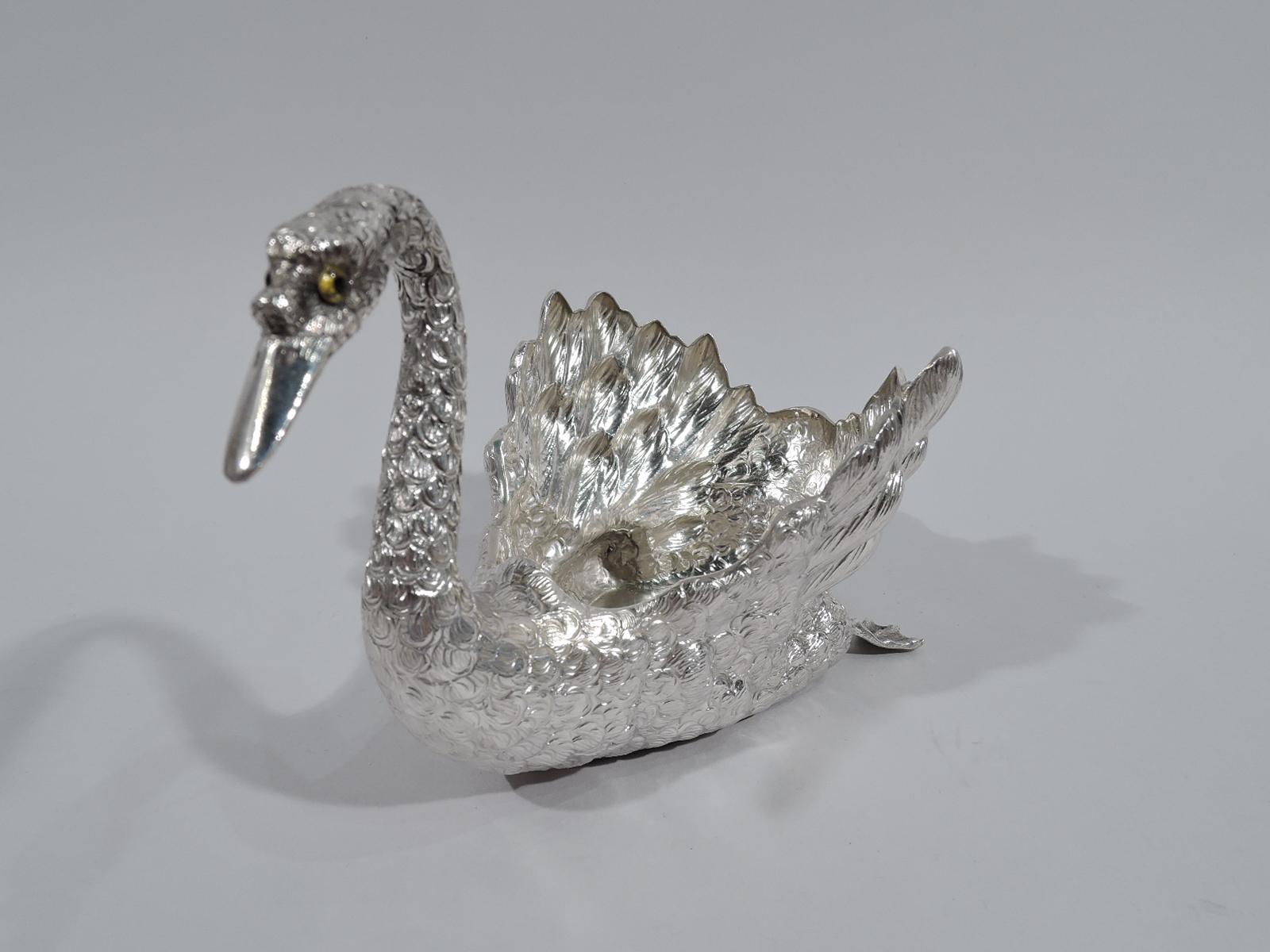 Elegant sterling silver swan. Made by Buccellati in Italy. Bird is in glide mode with flipped back paddle feet and head tilted slightly to side with intent gaze. Eyes glass. Extra fine detail in the feathers from the scaly neck to the down tail