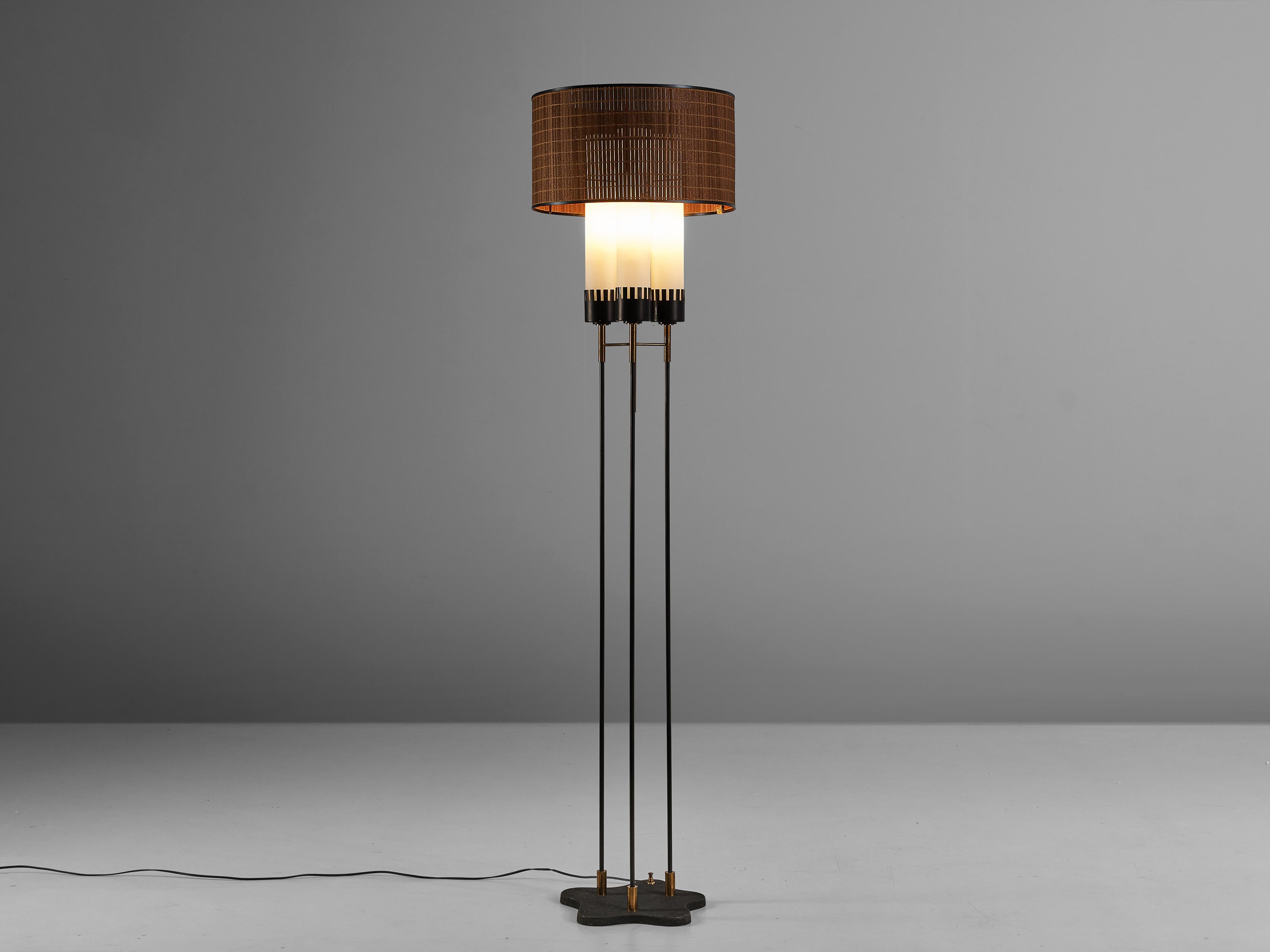 Stilnovo, floor lamp, metal, glass, brass, Italy, 1950s

Admirable Italian floor lamp by Italian manufacturer Stilnovo. An elegant ring in black with rotan surrounds three cylindric shade in opaline glass. From a organic shaped foot in metal three