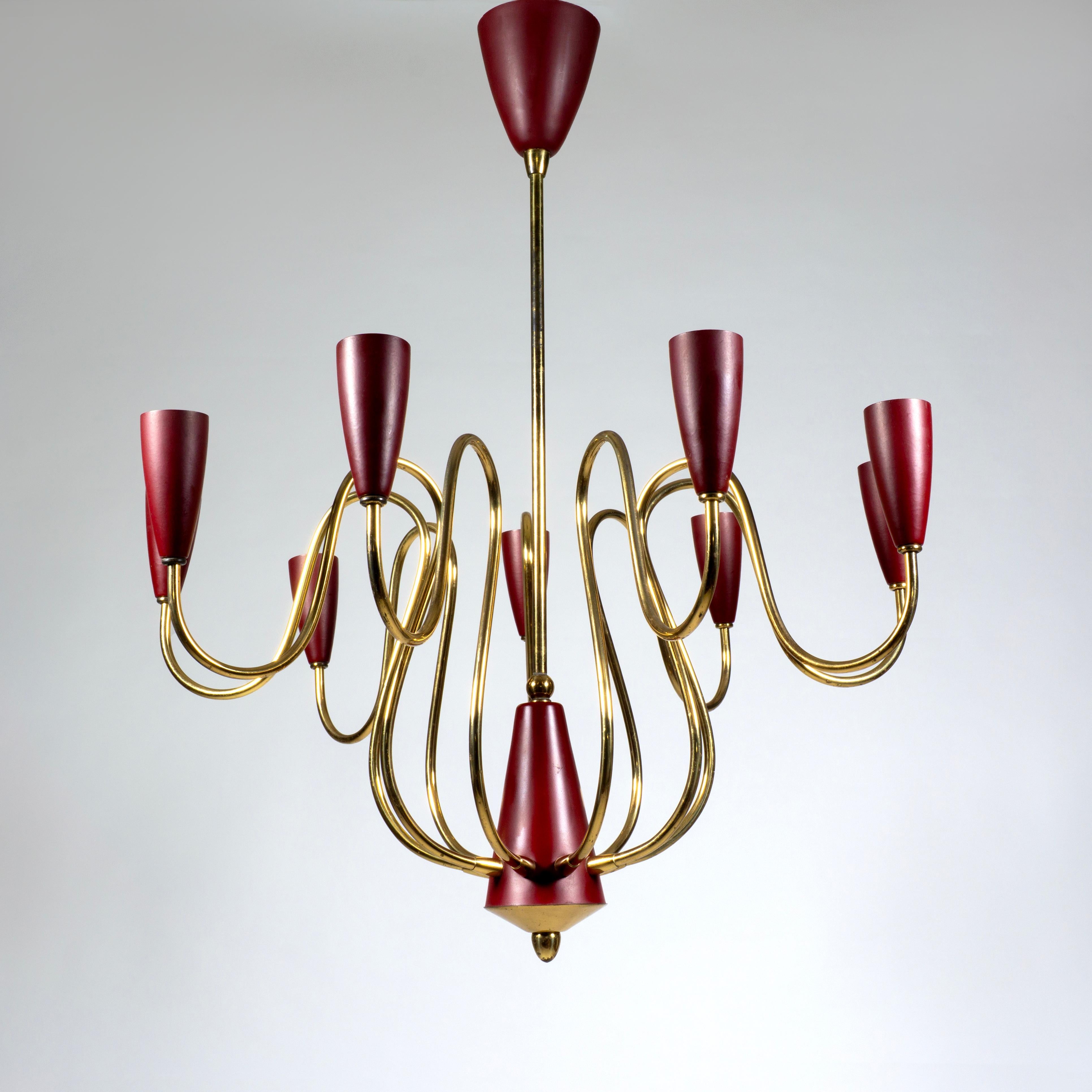 Stunning and very elegant Stilnovo nine-arm pendant chandelier.
This magnificent chandelier from the 1950s is fitted with nine curved brass arms, each with a dark red/burgundy lacquered lamp holder.
This large vintage Spider chandelier is an