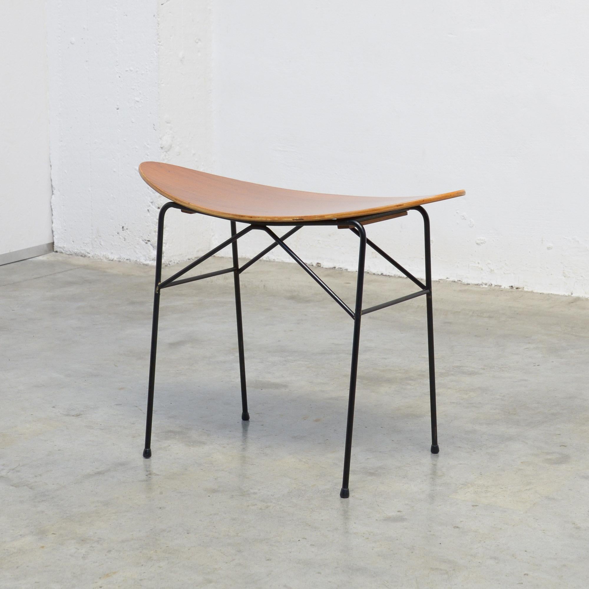 This elegant stool was manufactured by the Swedish furniture company Ulferts Tibro. It can be dated in the 1950s.
The black lacquered iron base holds the molded teak plywood seat.
This rare stool is in very good condition.