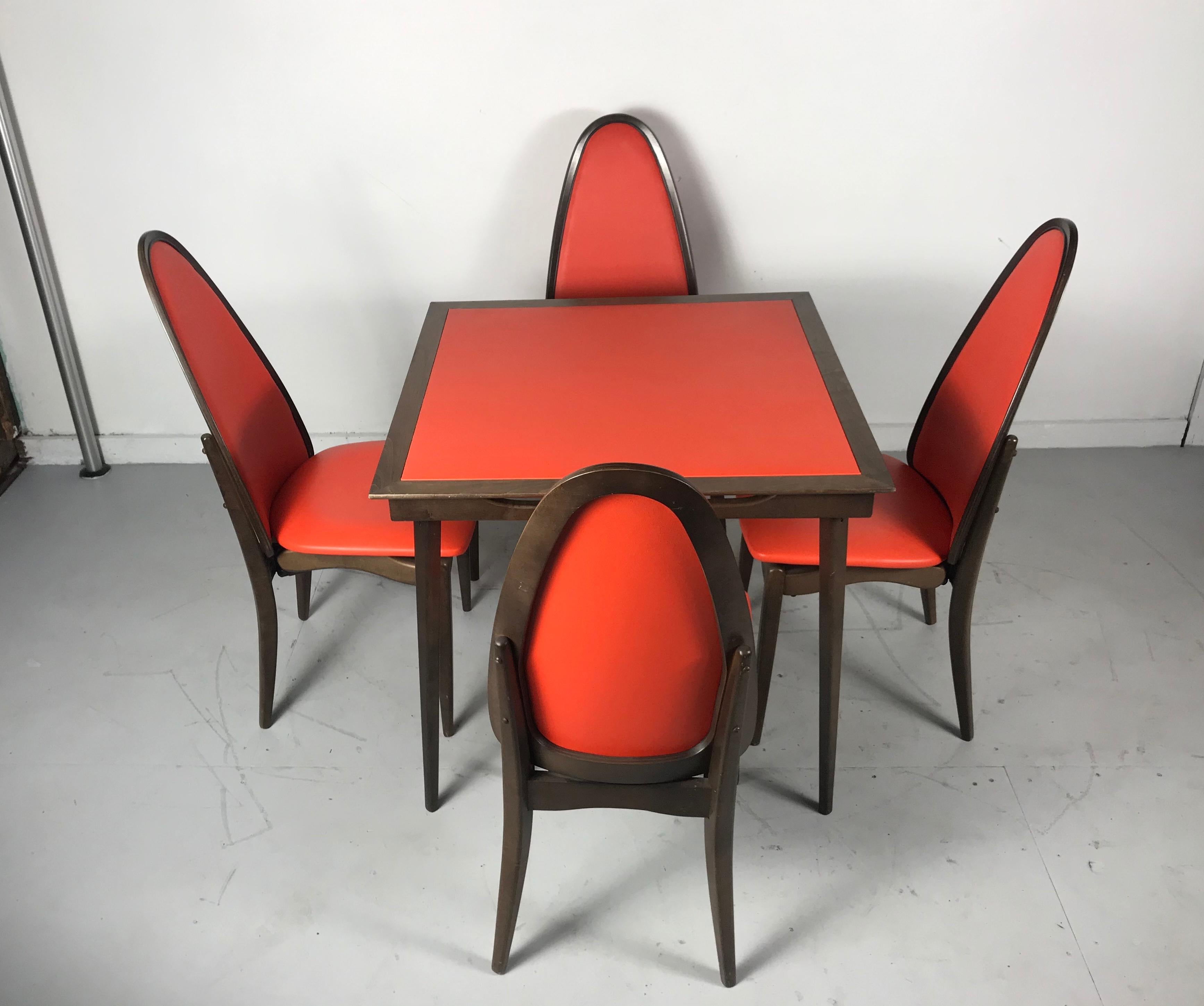 Elegant stylized folding table and chairs mfg by Stakmore Furniture Co., amazing quality and construction, no wonder they're slogan is the folding furniture with the permanent look.....retains original bright orange Naugahyde upholstery and tabletop