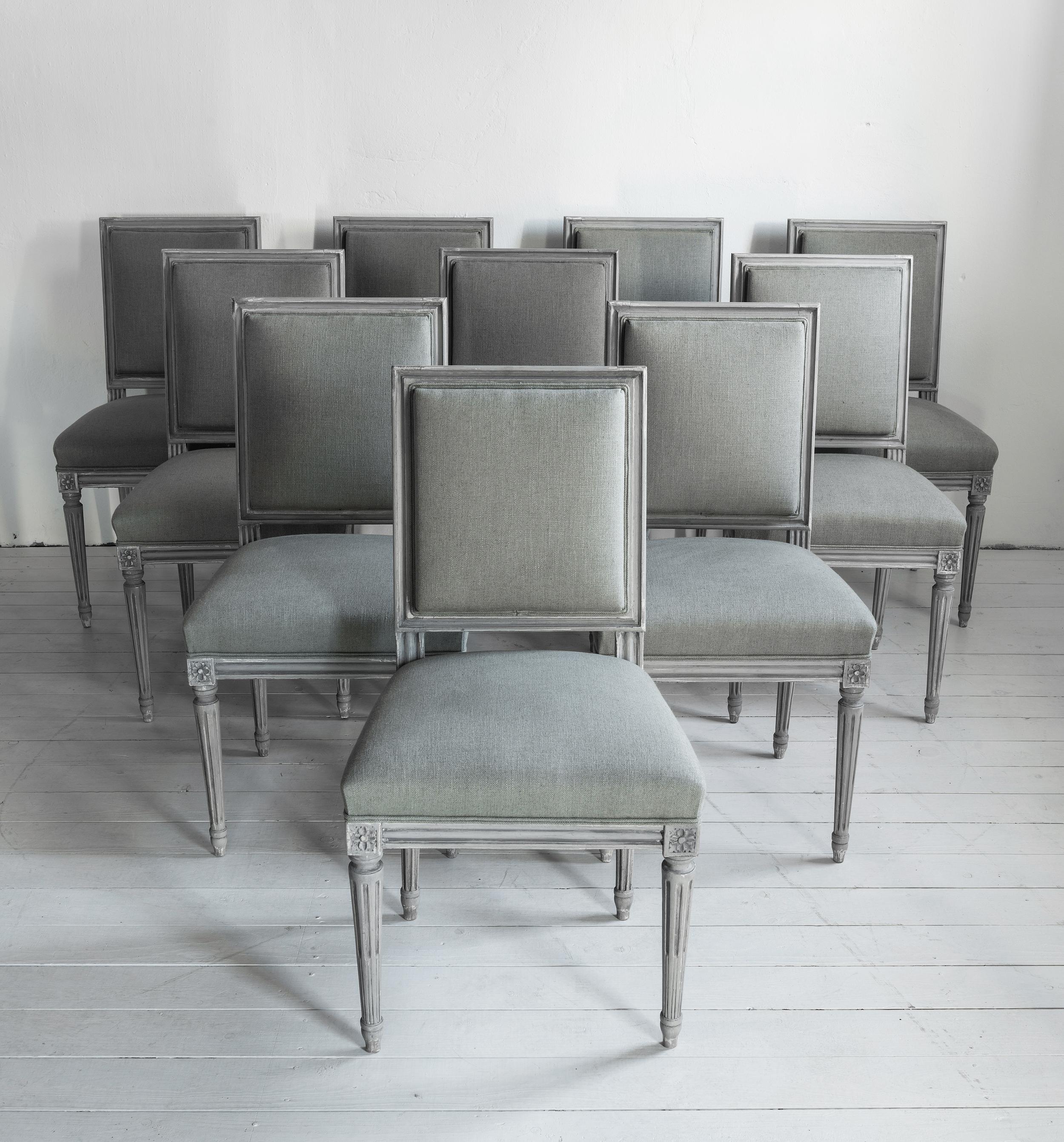 An elegant set of 8 + 2 dining chairs, having been completely stripped and reupholsterted using an mid grey linen blend fabric. Very elegant Louis XVI form. Two chairs are just slightly different, hardly noticeable. We would place these as carvers.