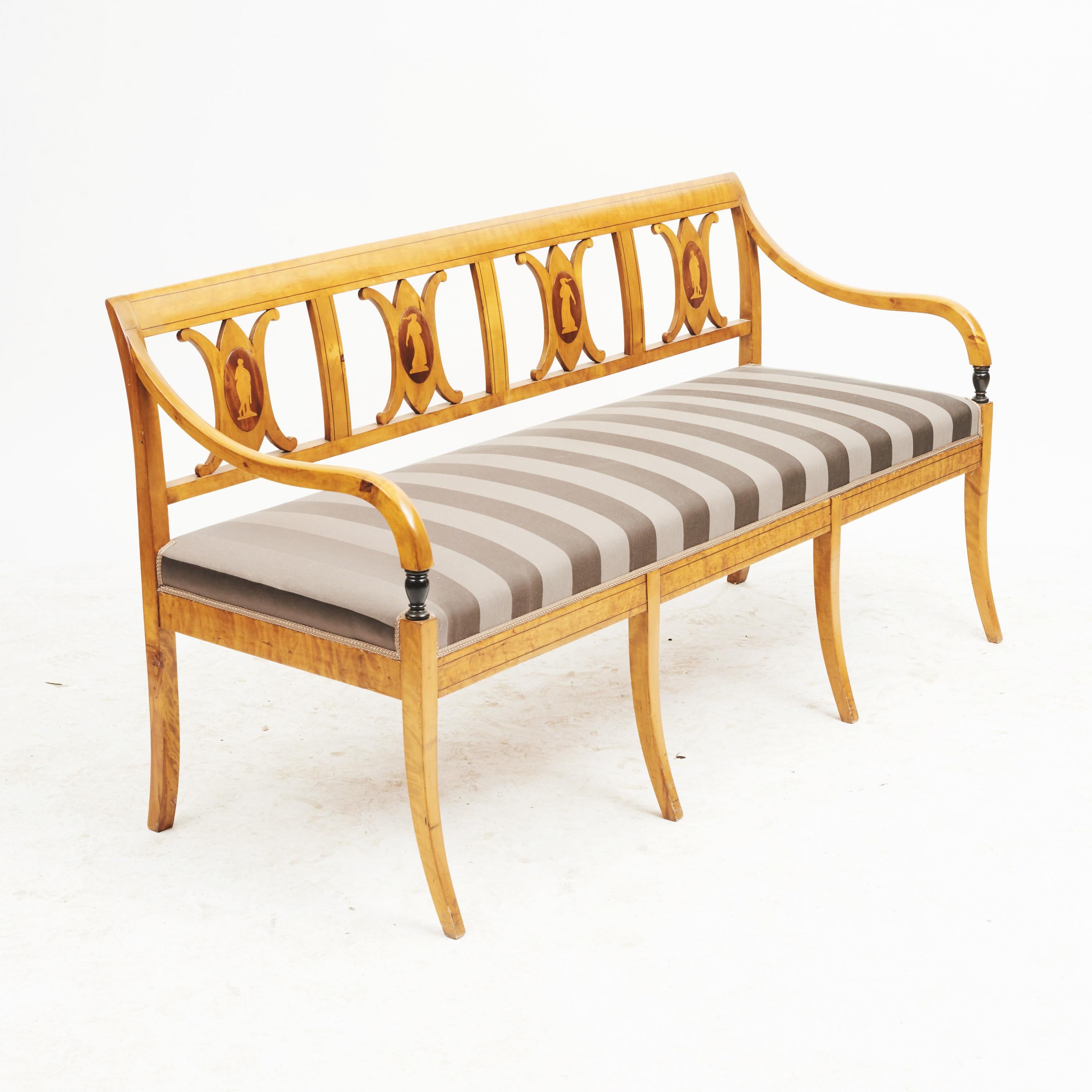 Elegant Swedish Empire bench in birch with inlays, Sweden, circa 1810.
The backs with inlays in the form of Greek female figures.
Beautifully executed. The set is reupholstered in fabric from Villa Nova.