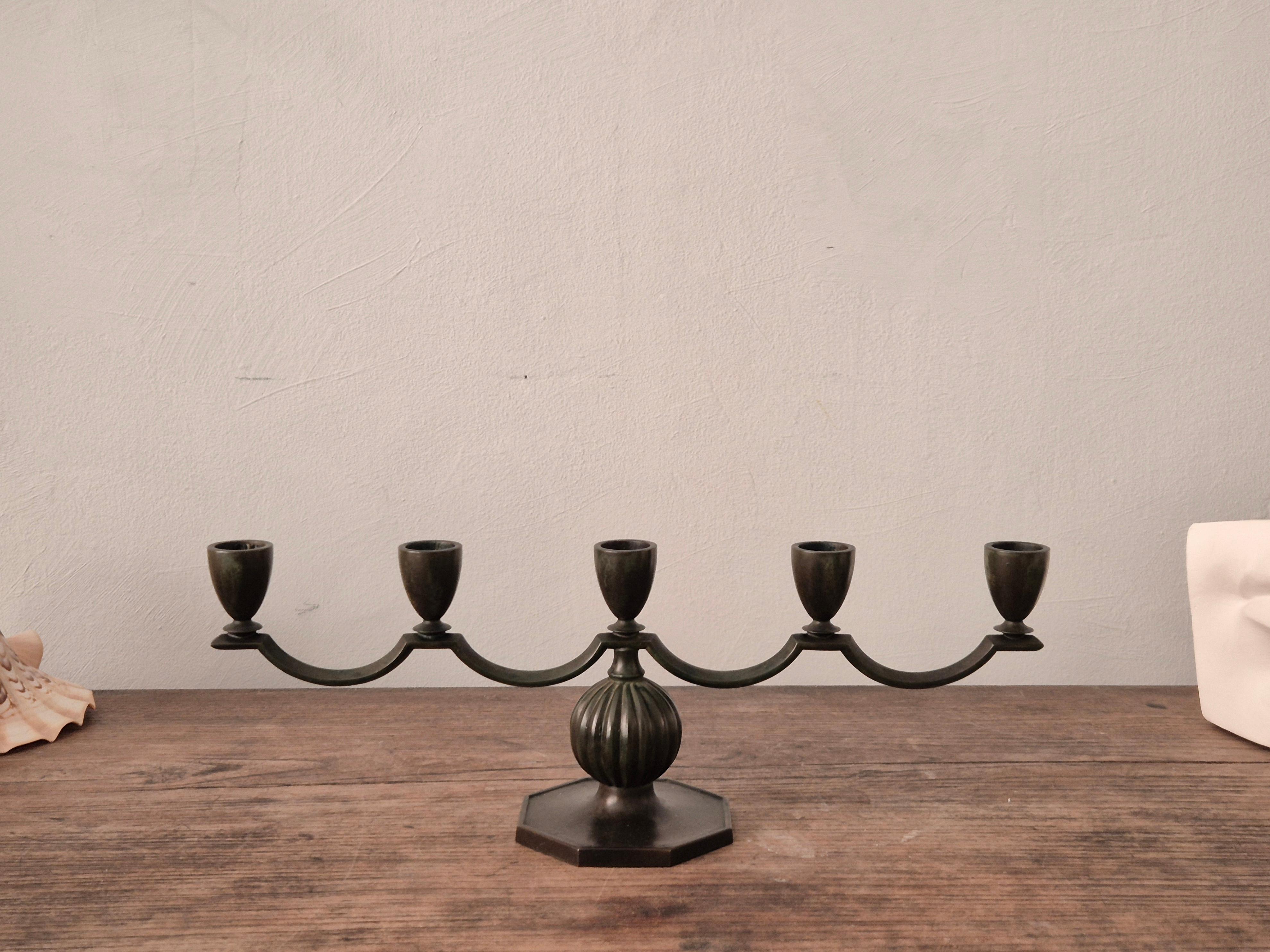 A decorative, solid bronze candelabra with  by Jacob Ängman for GAB / Guldaktiebolaget. With antique patina finish. Sweden, 1920/30s - Art Deco / Swedish Grace. In beautiful condition, smaller signs of age and wear. 

Marked: GAB Brons, 91