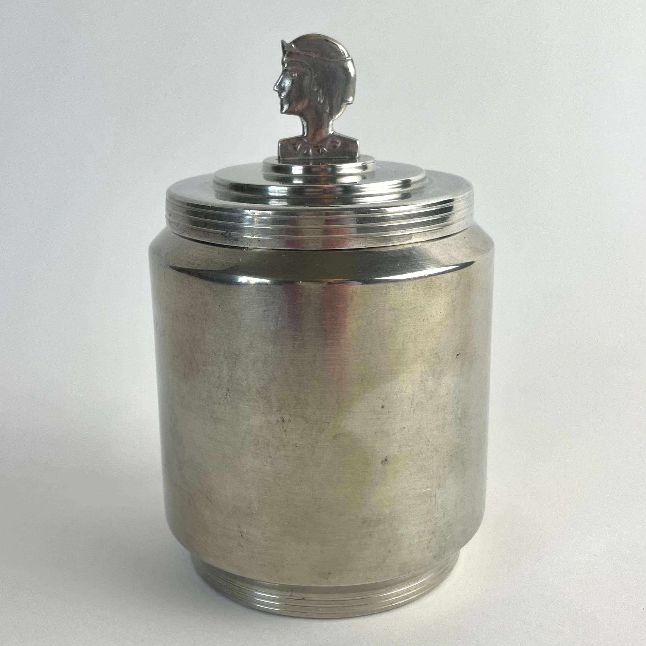 
Elegant Swedish Grace Pewter Jar, Dated 1937 – with Stylized Female Finial

A rare and beautifully crafted pewter jar from 1937, representative of the refined Swedish Grace style of the interwar period. This cylindrical lidded vessel features