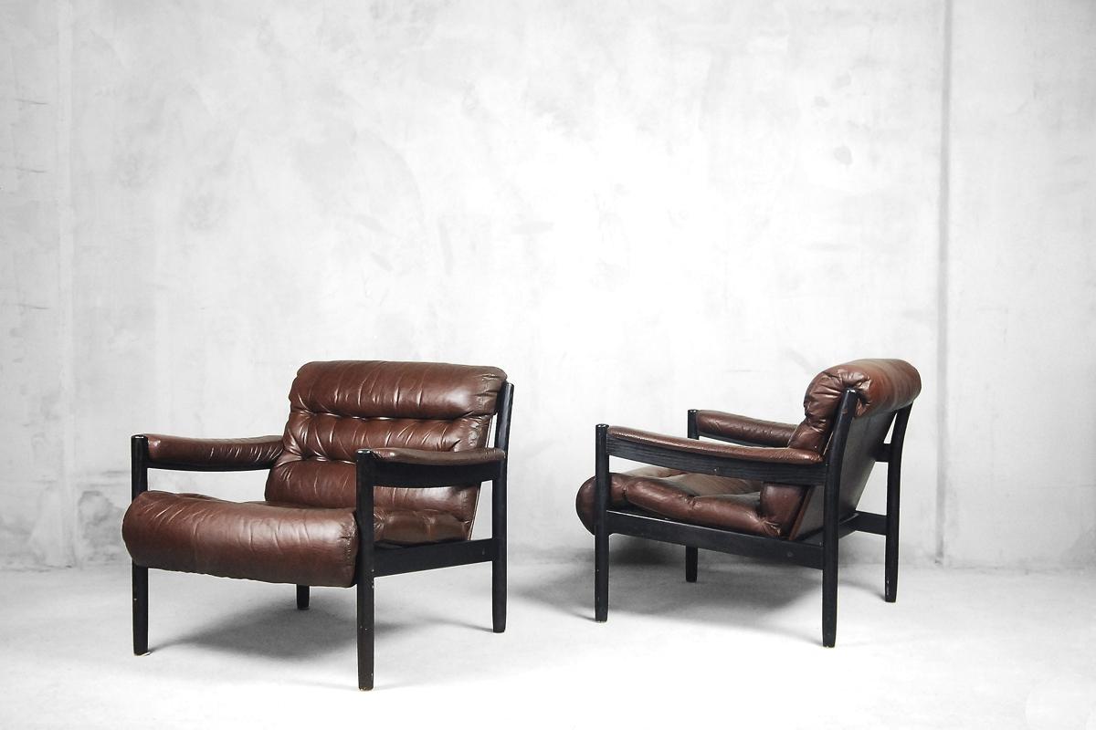 This elegant set of two chairs was manufactured in Sweden during the 1970s. It is a perfect choose for office or cabinet. The frame was made from solid wood in dark color and the seat was upholstered in real leather in deep brown color.

DUX is