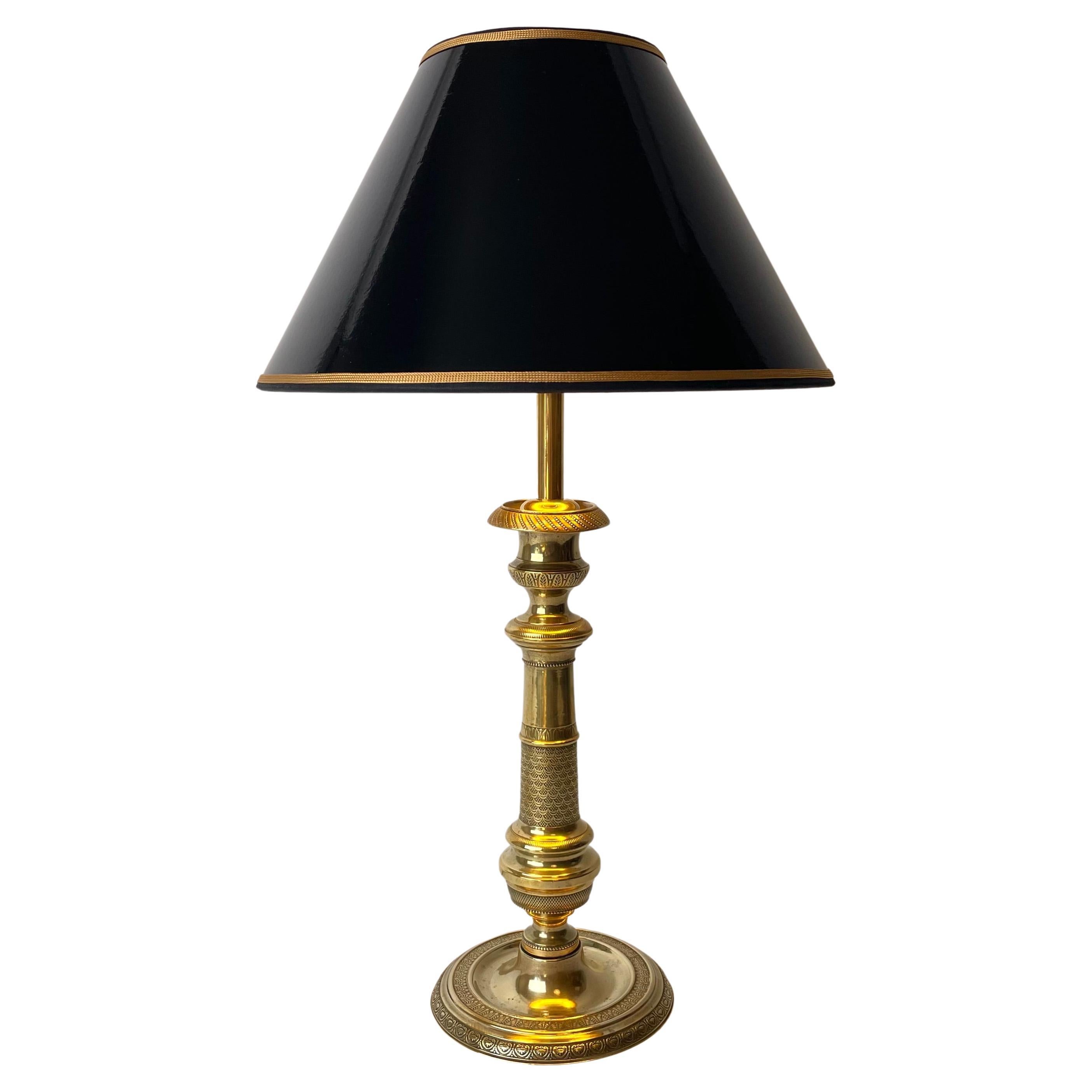Table Lamp in Brass. Made in France during the 1820s, converted into a table lamp during the 20th century. 
Base decorated with two different types of palmette patterns. Column decorated with finely ornamented diagonally checkered pattern as well as