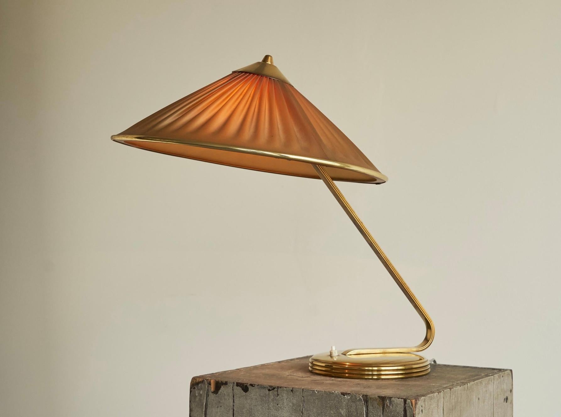 Elegant Table Lamp in Brass and Plissé Shade, Europe, 1950s.

This special table lamp in brass is from the 1950s, most likely originating from France. With its slightly tilted plissé shade and refined details in the base, it shows elegance and