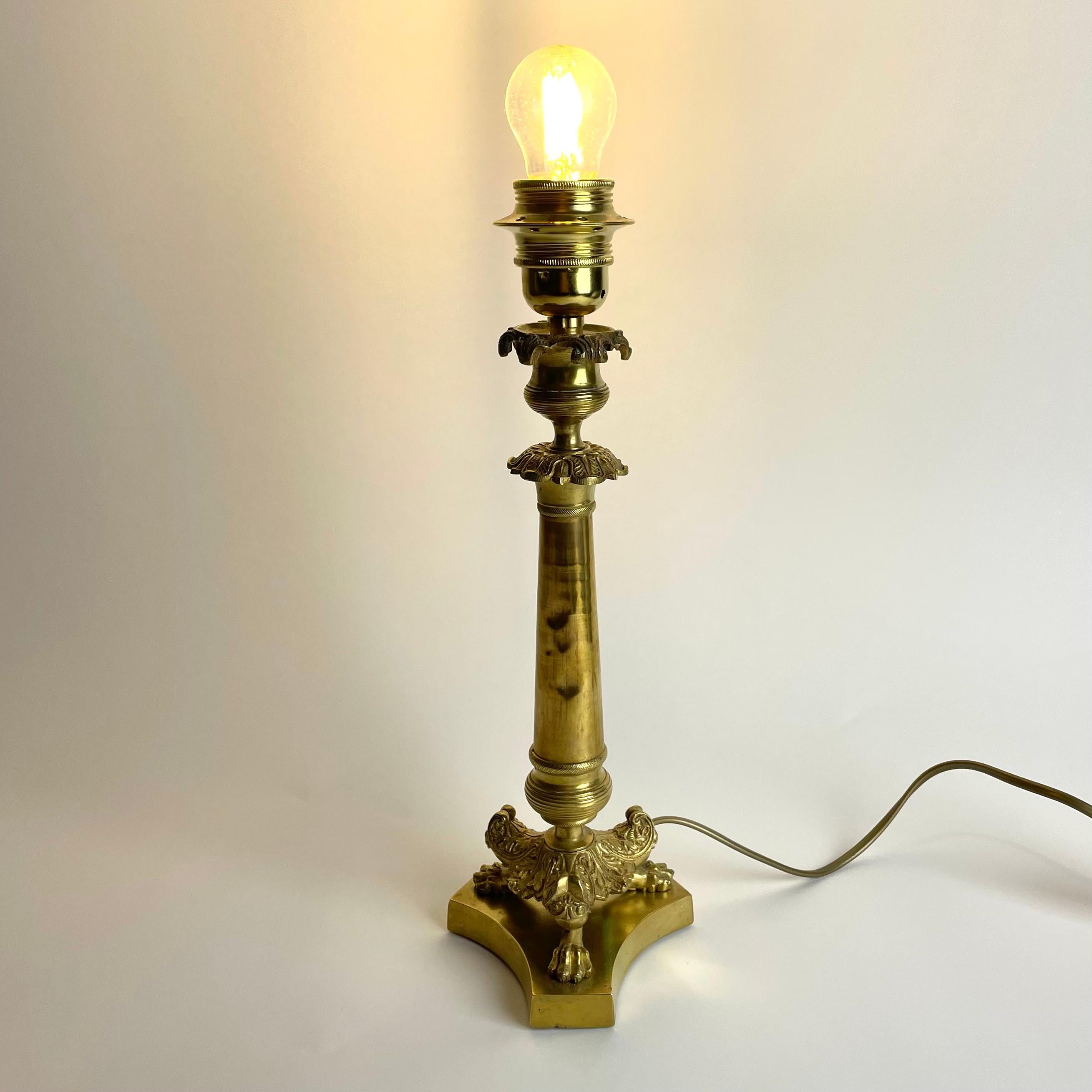 French Elegant Table Lamp in bronze. Originally an Empire candlestick from the 1820s For Sale