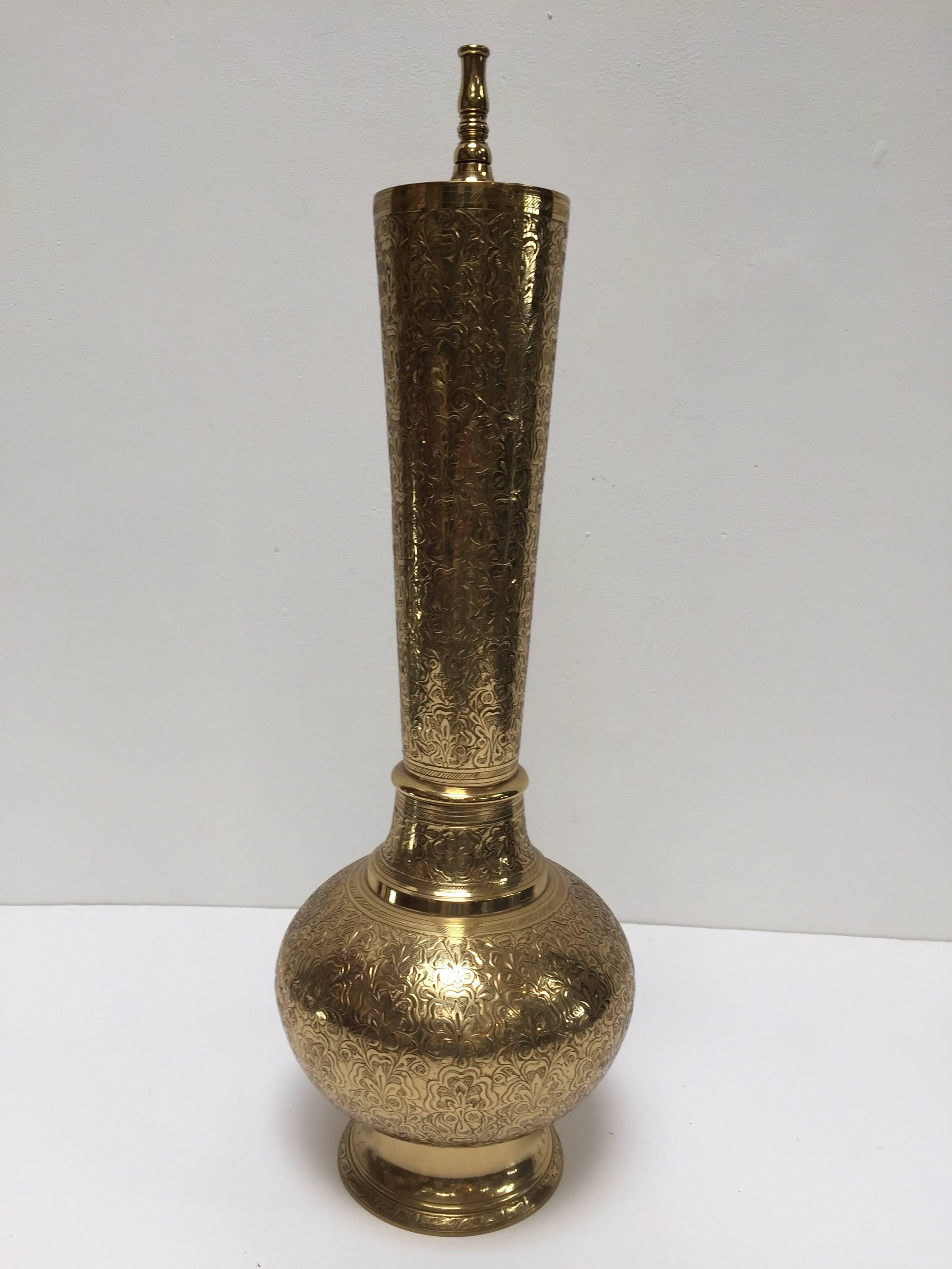 Elegant tall Moorish polished brass incense burner made into a lamp base.
Intricately carved chiseled polished brass onion- form with long neck on a circular base.
Could easily be rewired and converted to a table lamp, holes are already there for