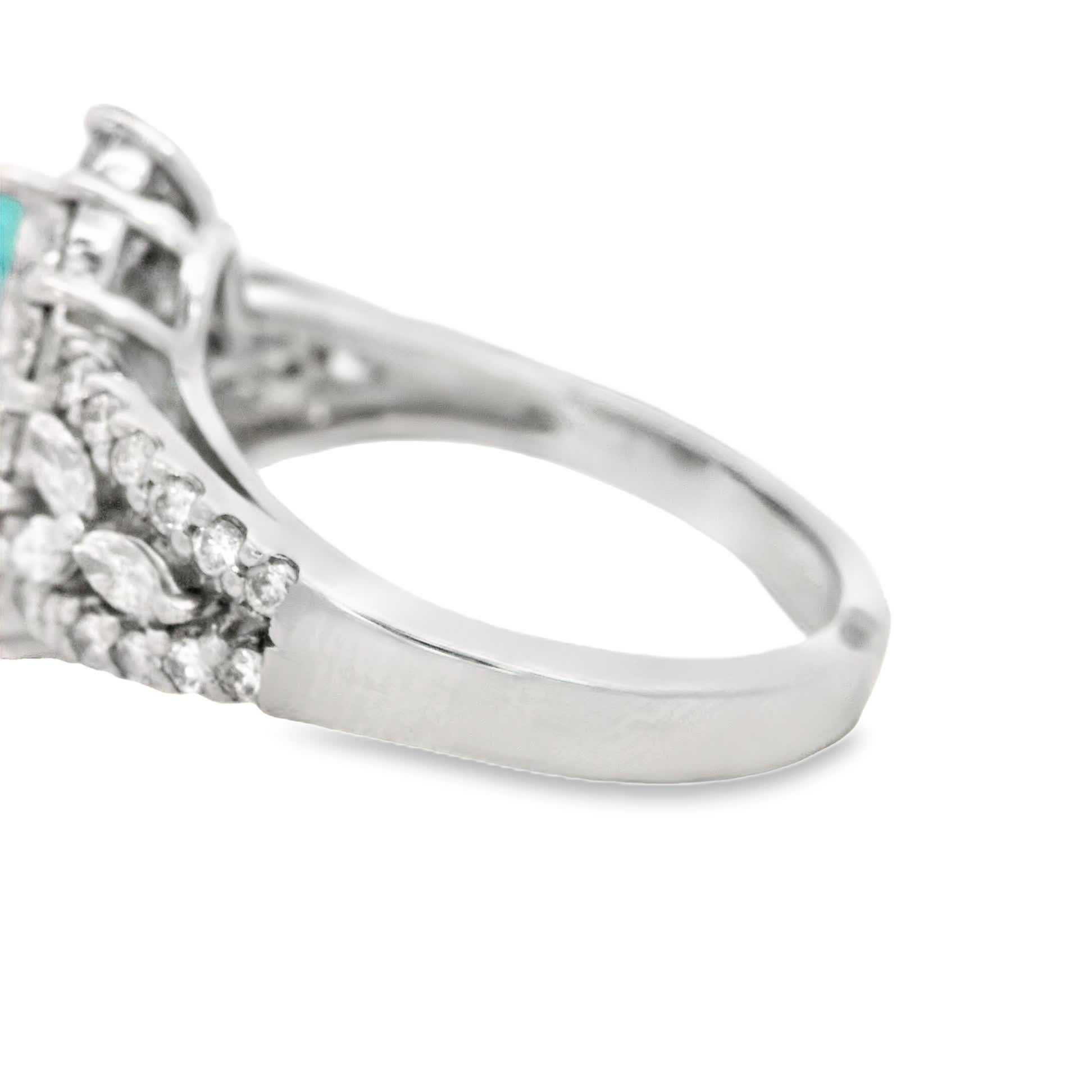 Discover the exquisite beauty of this teardrop aquamarine ring, surrounded by a halo of sparkling diamonds. The stunning blue hue of the aquamarine captures the essence of tranquility, making it a perfect statement piece for any occasion.