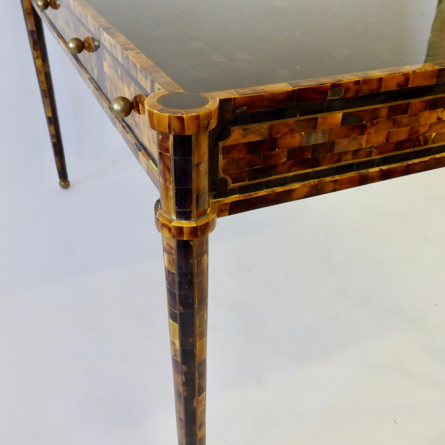 Elegant writing desk with three drawers on one side. Covered in rectangular horn tiles.