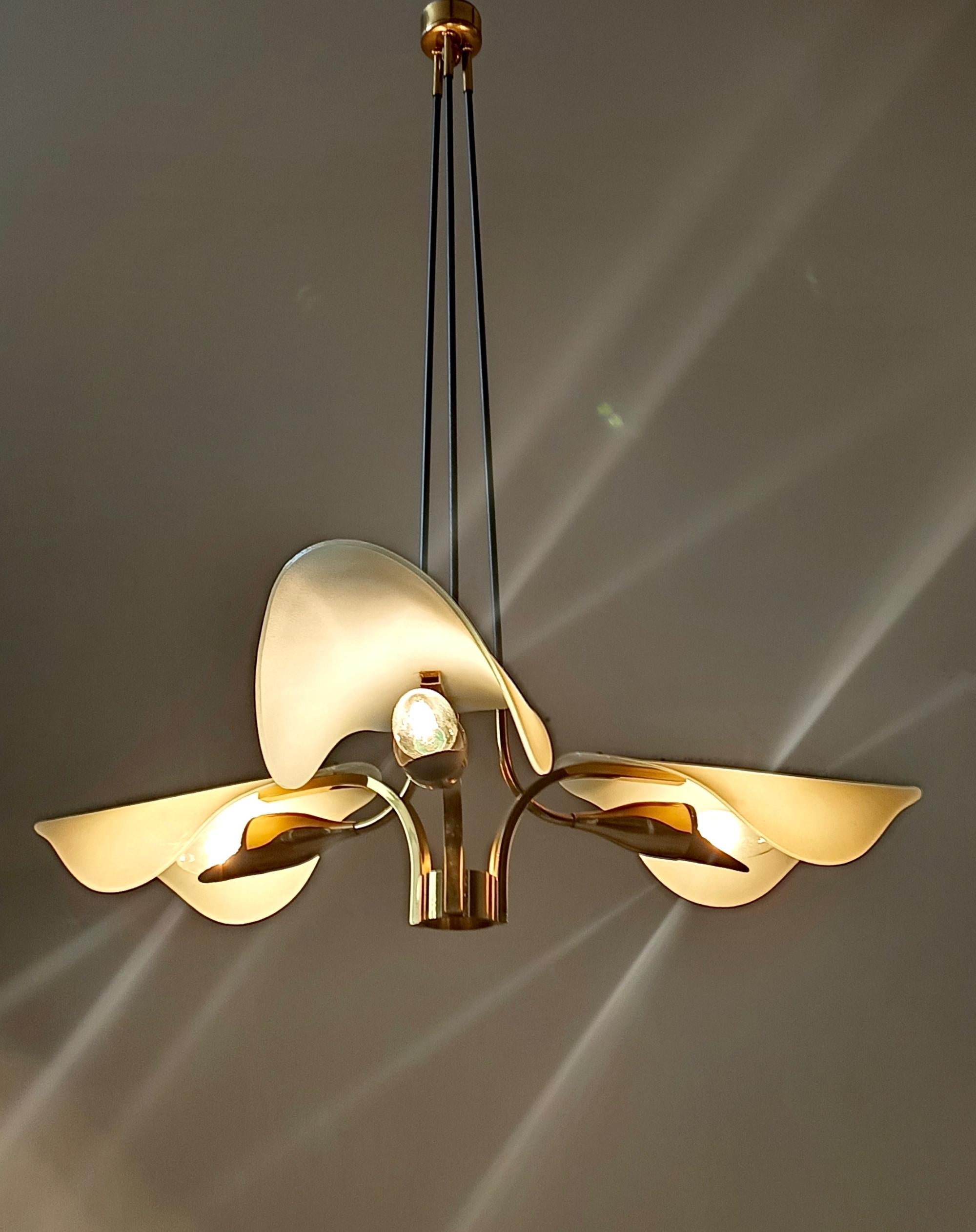 Made in Italy, 1950s.
It features three arms and is made in brass and glass. 
This chandelier may show slight traces of use since it's vintage, but it can be considered as in excellent original condition.
Compatible with the USA.

Measures: