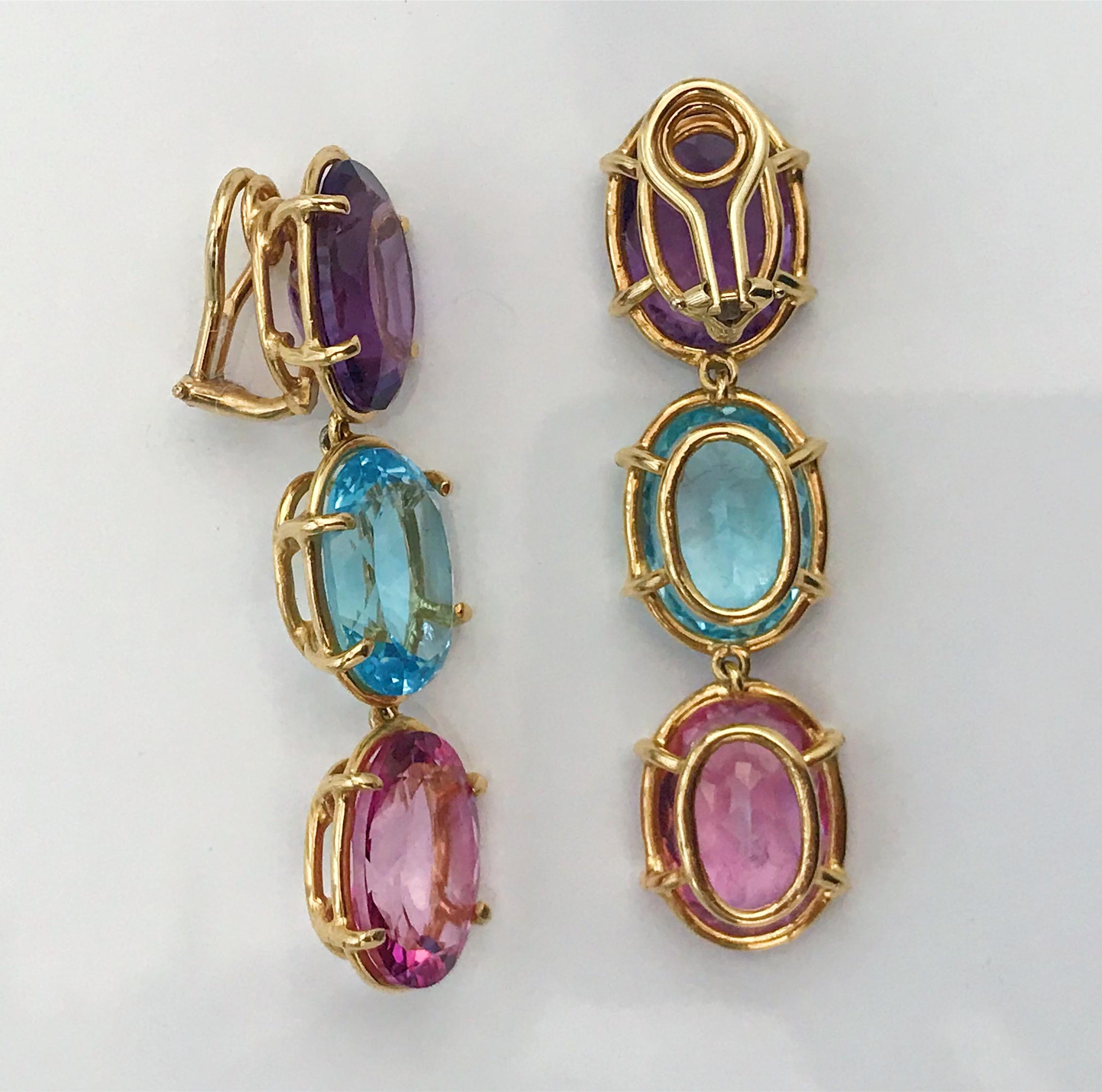 18kt Yellow Gold Elegant Three Stone Drop Earrings with faceted oval Amethyst and Blue Topaz and Pink Topaz

The Earrings measure 2 1/4 in length. The earrings can be made for Clip Earring or Pierced Earrings. They can also be custom made with any