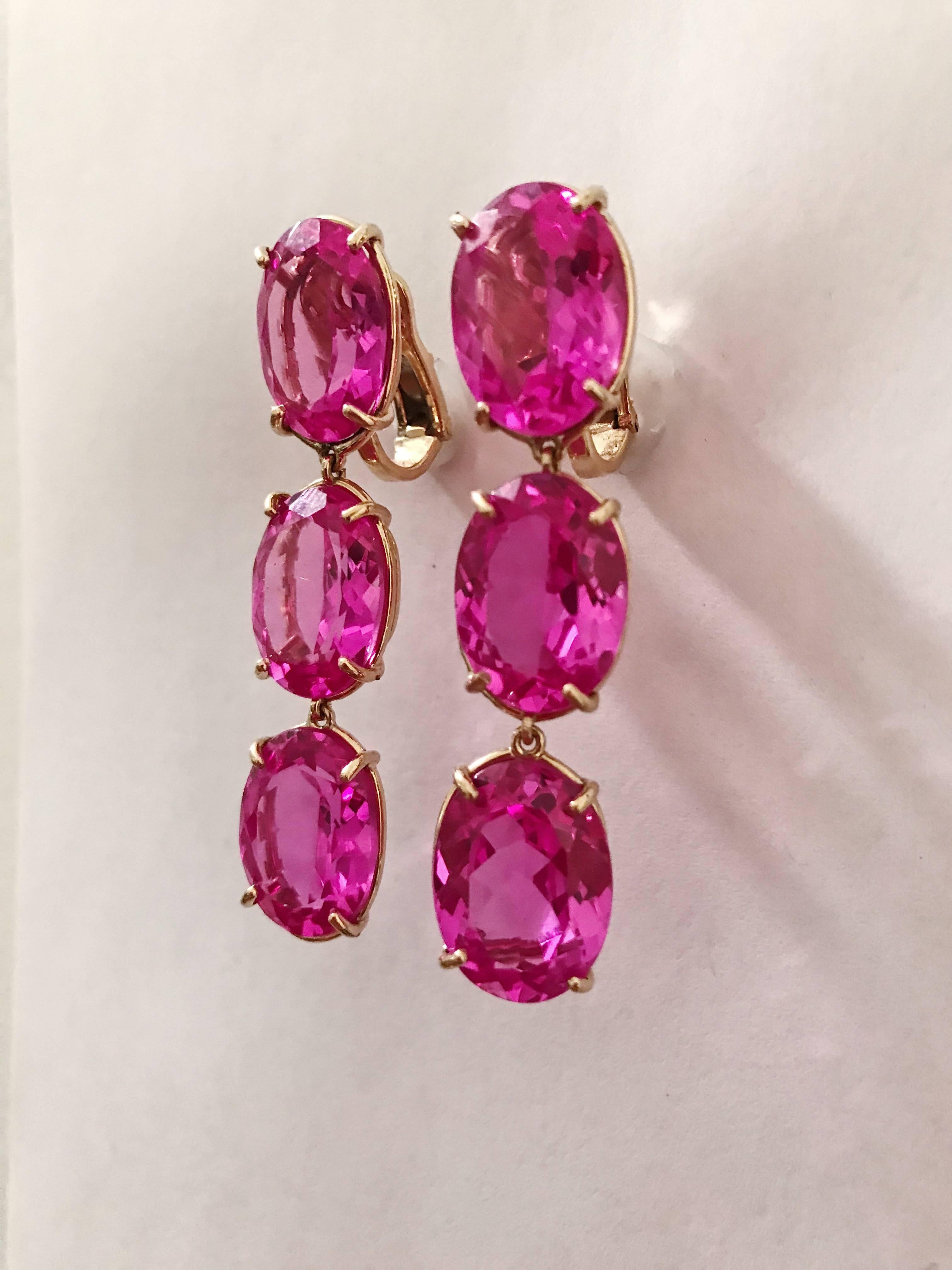 18kt Yellow Gold Elegant Three stone Drop Earrings with faceted oval Hot Pink Topaz. 

The Earrings measure 2 1/4 in length.

The earrings can be made for Clip Earring or Pierced Earrings.

They can also be custom made with and color stone