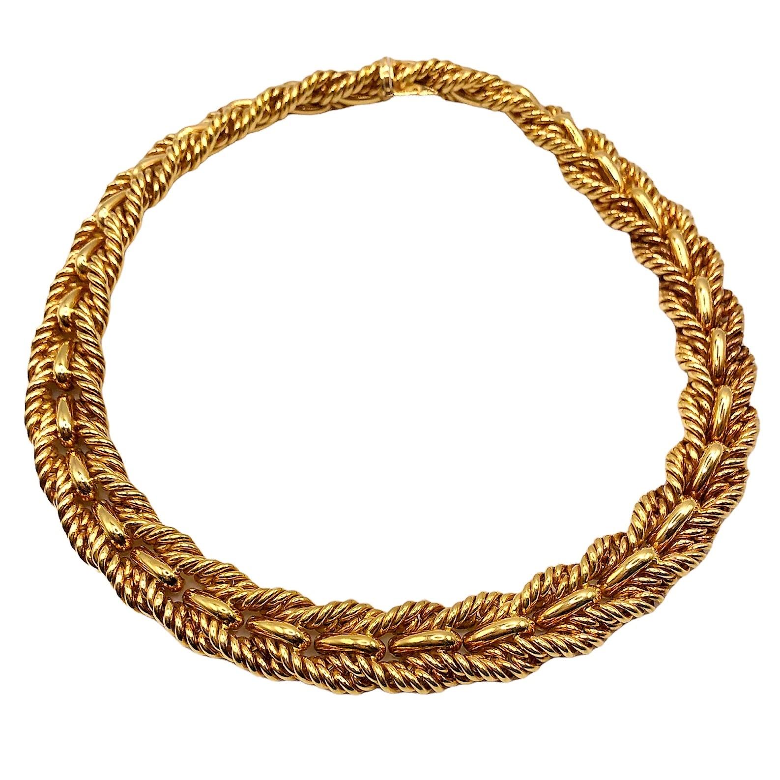 This elegant 18k yellow gold Tiffany & Co. necklace is designed with two rope edges bracketing a center line of repeating high polish bombe motifs. Measures 17 1/2 inches long by 5/8 inches wide. A rich patina adds to it's elegance. The inline