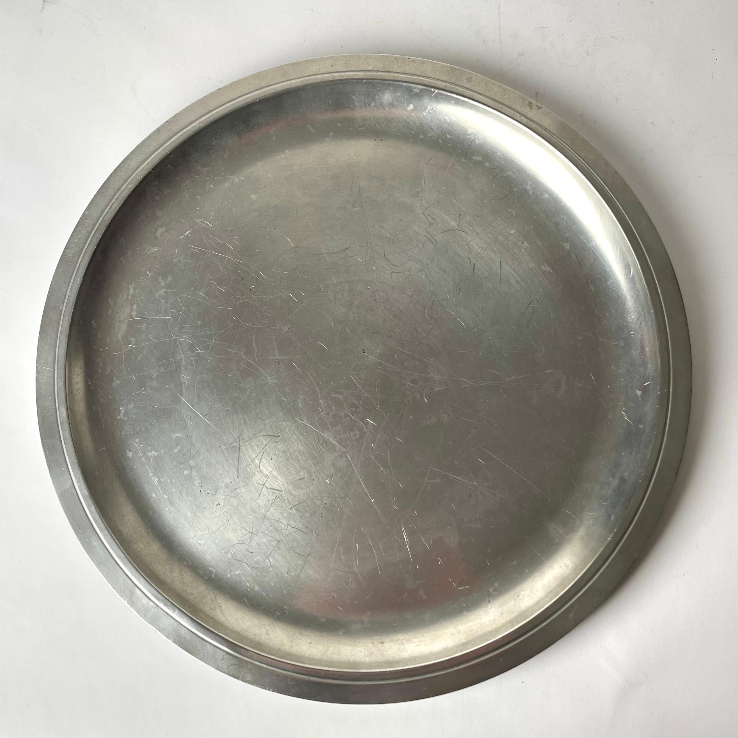Elegant Tray in pewter from Sweden’s most famous Design Company Firma Svenskt Tenn. Art Deco. This tray is from the year 1934 (H8). Simple beauty with only a stripe as decoration.

Wear consistent with age and use 
