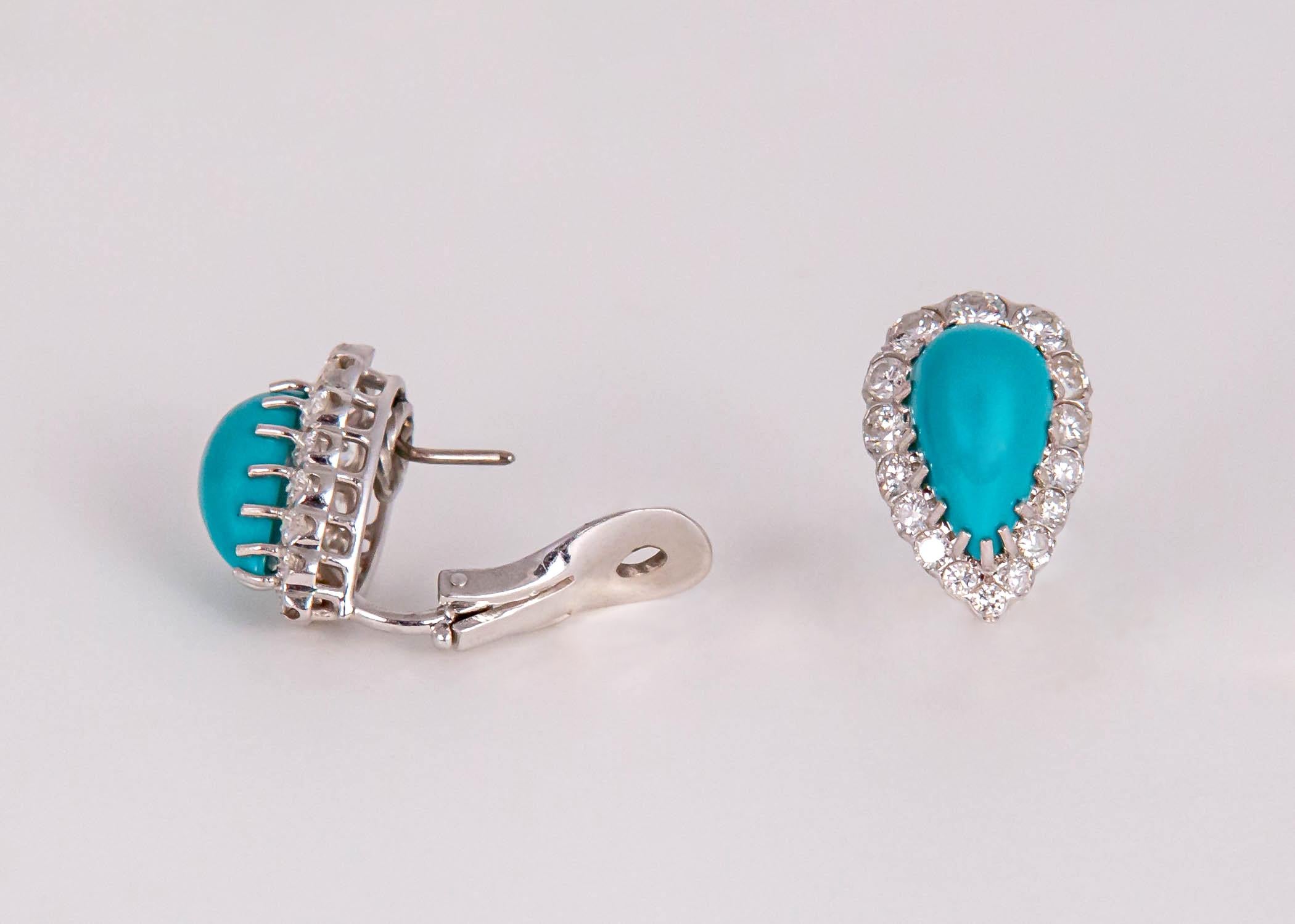 Beautifully matched turquoise are framed with brilliant cut diamonds in this elegant pair of earrings. The turquoise makes diamonds possible day to night. Just shy of 7/8's of an inch in length. 2.00 carats in diamond weight.