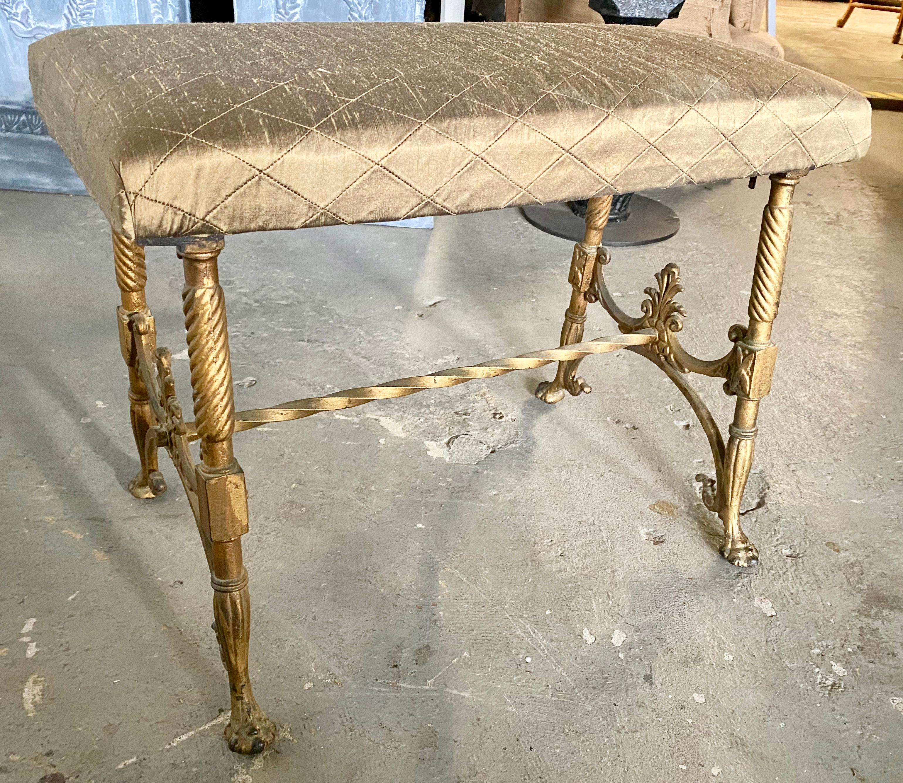 Antique Victorian period gold gilt cast iron metal bench. Seat is newly recovered in diamond pattern upholstery. Will make a wonderful extra seat in the boudoir or dressing room. 
Footstools
Ottomans and poufs
Stools
Hollywood Regency.

   