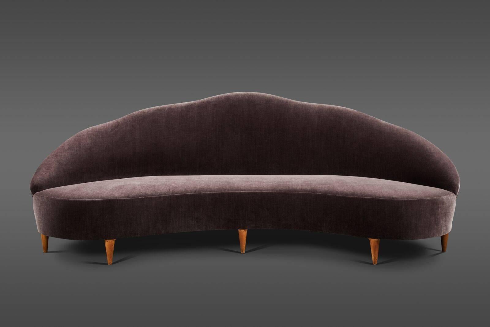 Curvilinear camelback sofa custom upholstered in sumptuous Claremont velvet with faint striations.
 