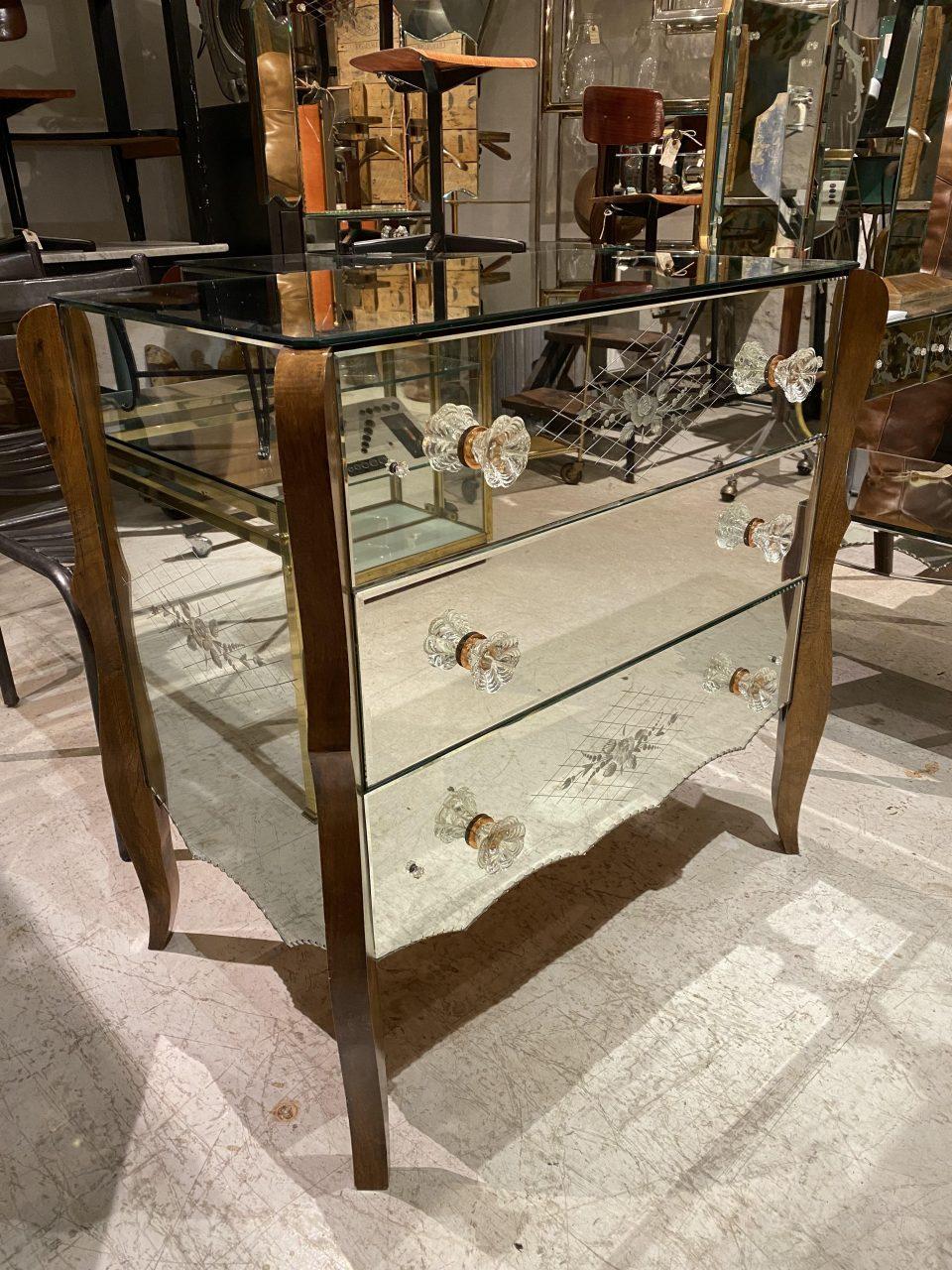 A gorgeous and rare Venetian-style mirrored dresser from 1940s France. The fronts and top have beautiful vintage facet-cut mirror glass, engraved with charming floral motifs.

Kindly also note the lovely glass handles and elegant dark wood tall