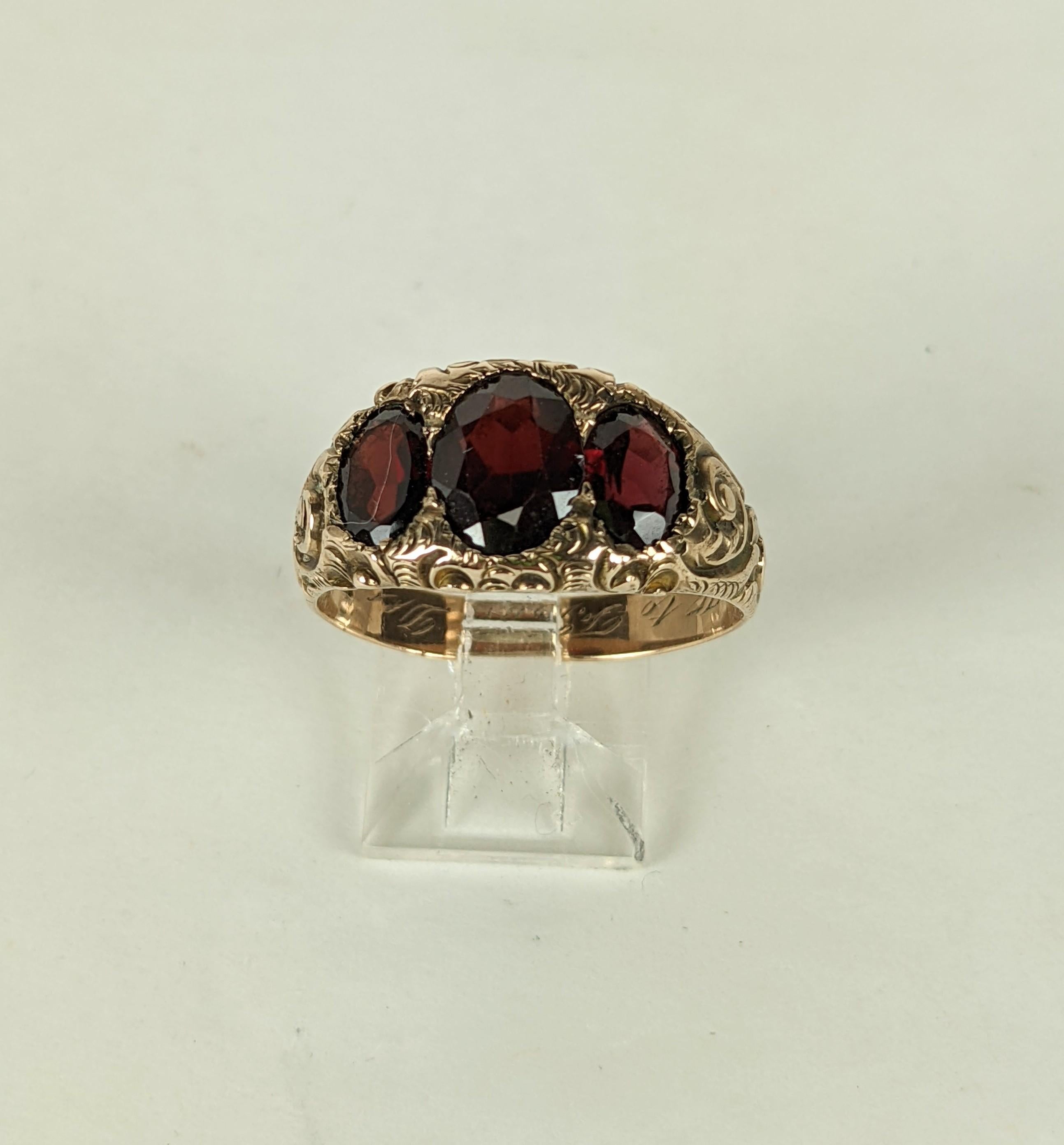 Attractive Victorian Garnet 3 Stone Ring mid 19th C in 14k gold. Oval cut garnets are set into an elaborate hand etched scroll work setting. 
Elegant and great for anyone. 1900's USA. Interior has inscribed Initials, 12-25-1915, 
Size 8.5-9. 