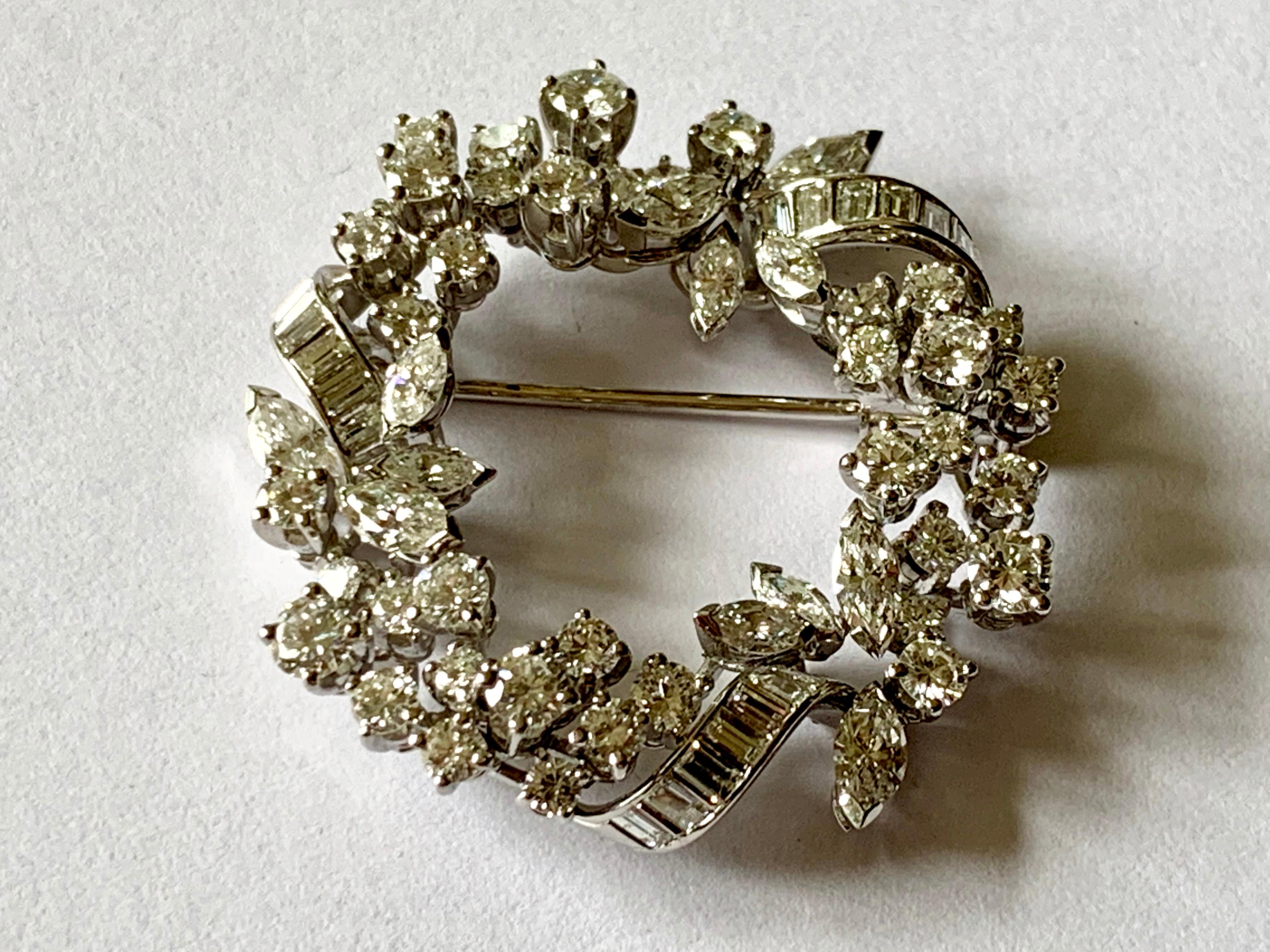 This gorgeous 18 K white Gold  brooch by the well known and established swiss company Meister is designed as a circular motif and contains 38 round brilliant diamonds, 12 Marquise Diamonds and 21 Baguette Diamonds with a total Diamond weight of