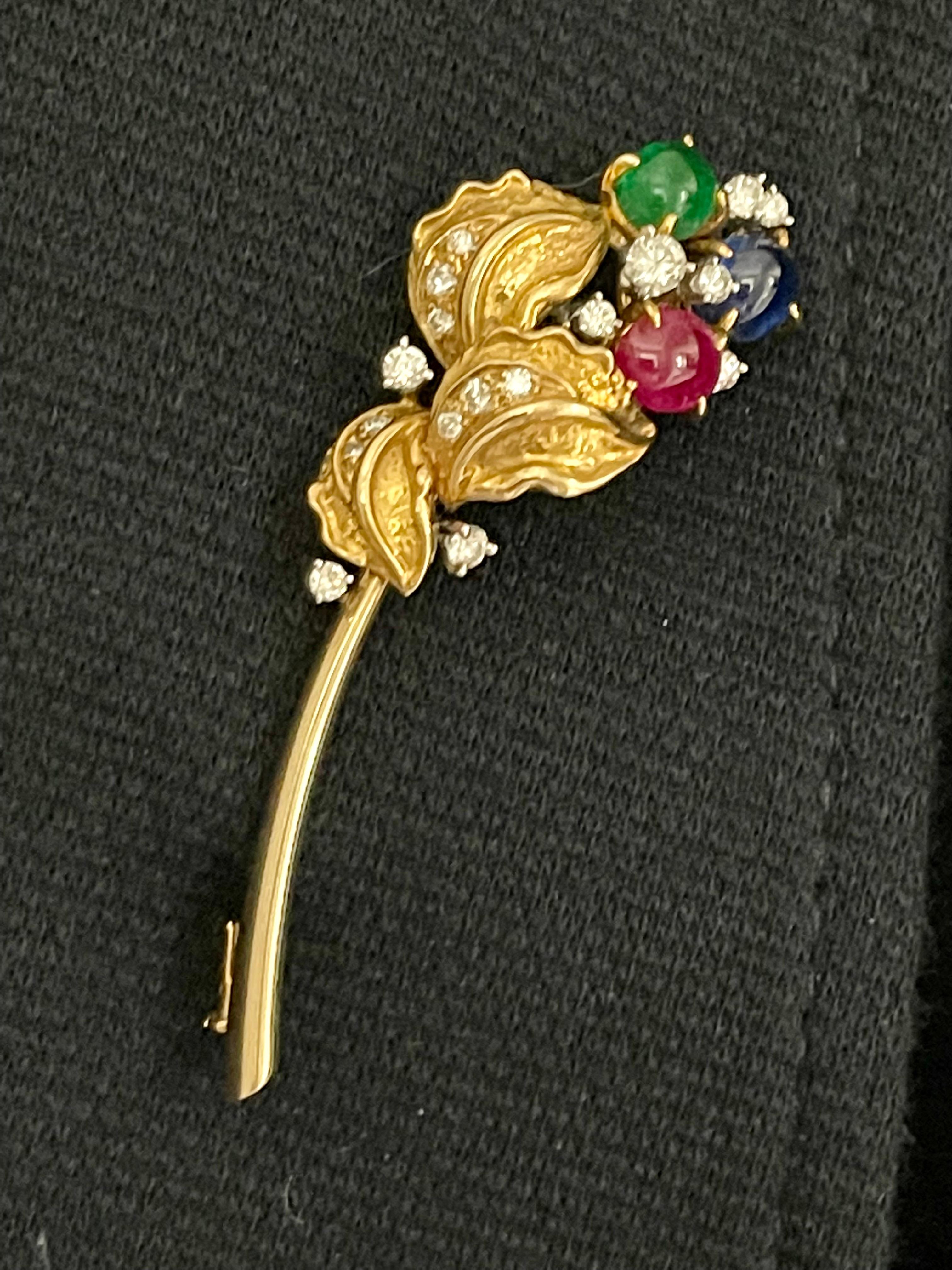 Very elegant floral stlye brooch in 18 K yellow Gold made by internationally  well-known swiss jeweller Meister Zurich. The brooch festures 3 top quality colored stones like Emerald, Ruby and Sapphire. It is very rare to find this intense and deep