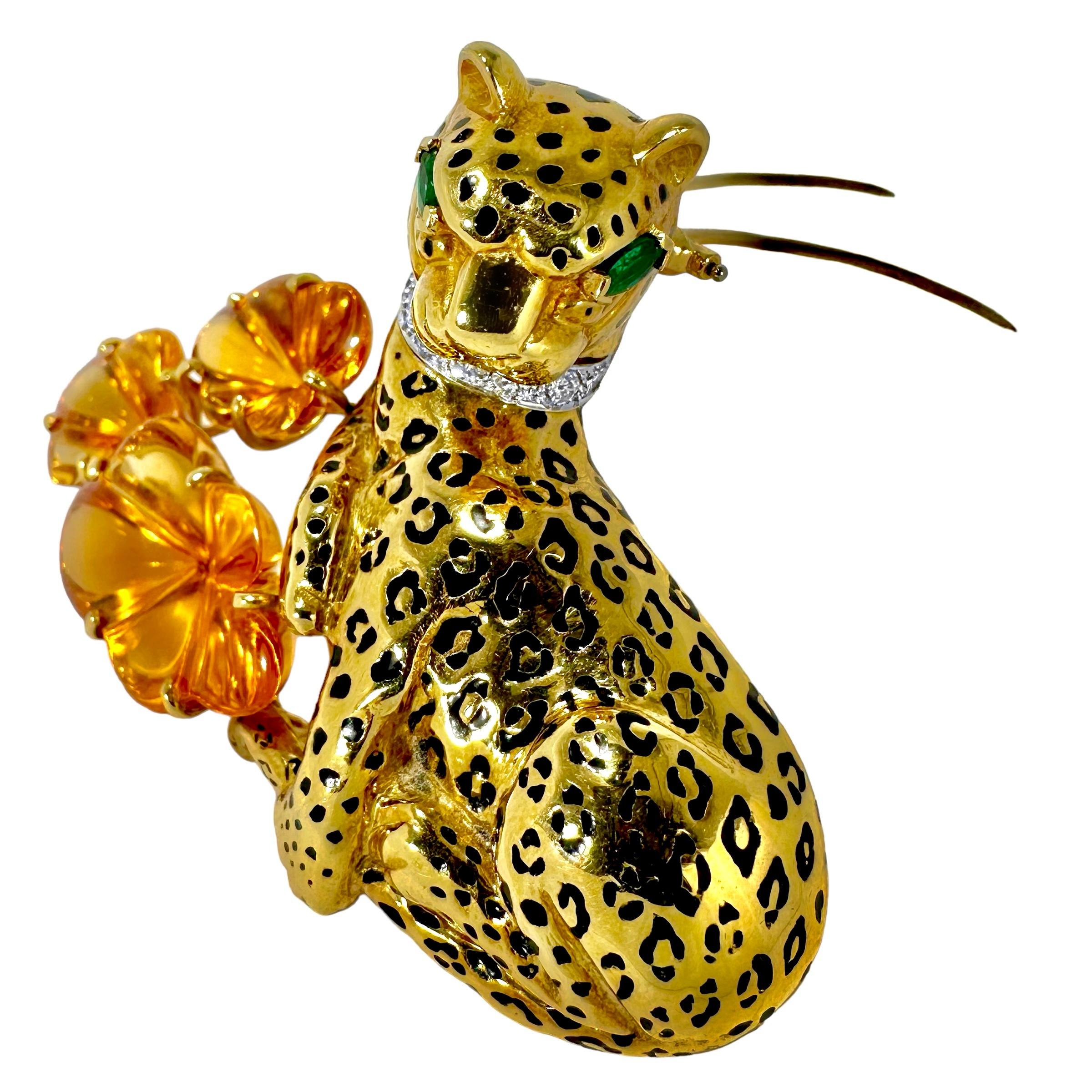 This very artistic and deftly crafted leopard, resting on a bed of golden flowers, is truly high art in every sense. The very lifelike creature is fashioned in 18k yellow gold with black enamel spots, lush green emerald eyes, and a diamond collar.