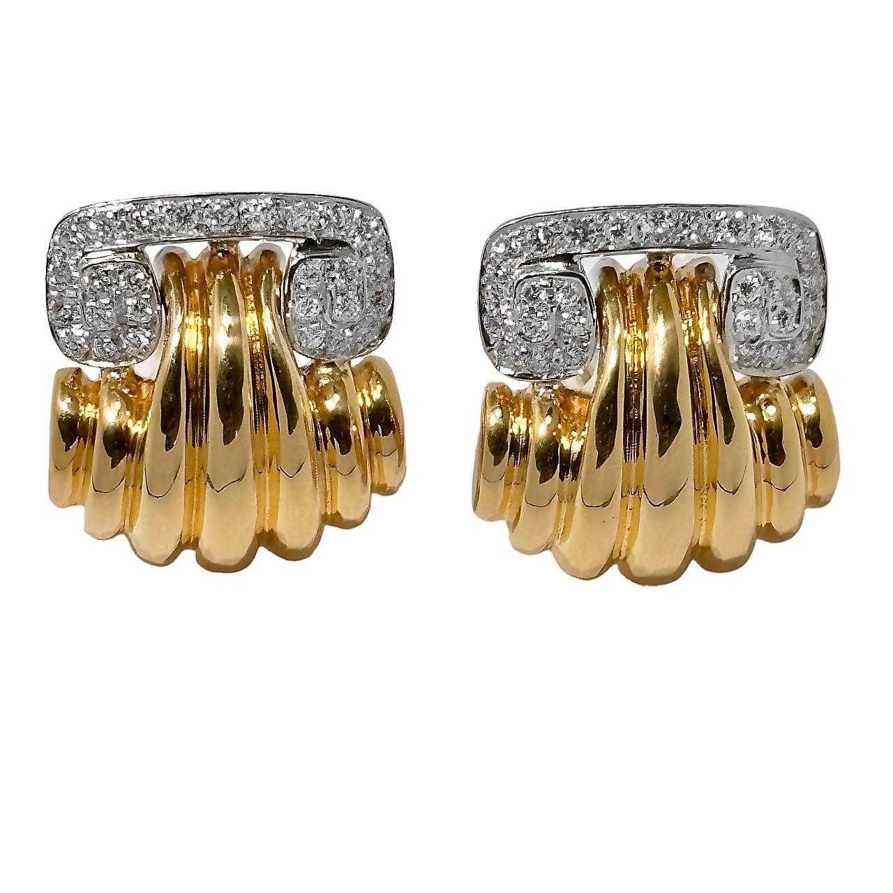 This bold and finely crafted pair of mid-20th Century 18k gold clip on earrings are comprised of white gold tops encrusted with brilliant cut diamonds, wedded to boldly fluted rich 18k yellow bottoms. A total of 54 brilliant cut diamonds having a