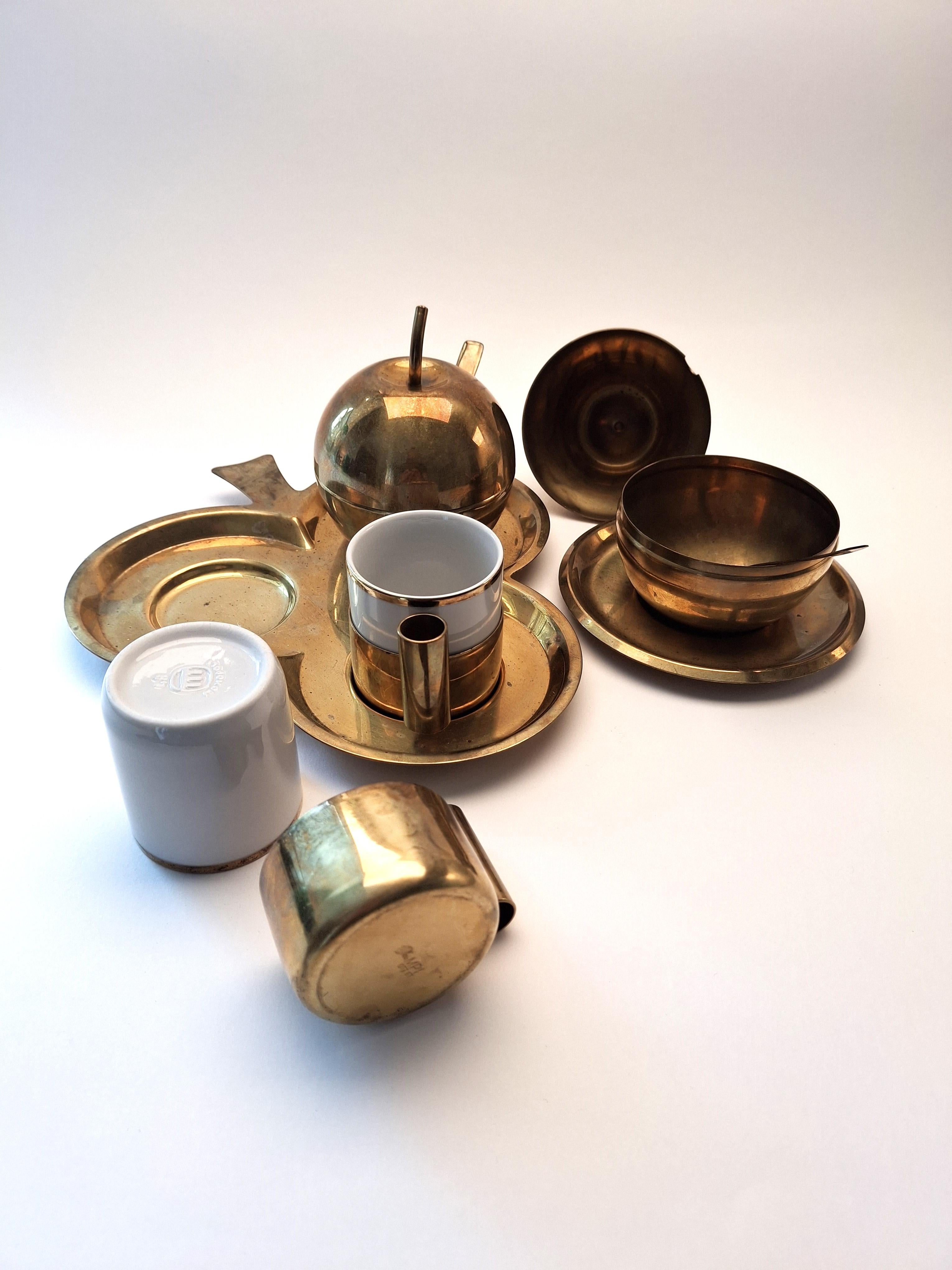 Elevate your coffee moments with this exquisite vintage coffee set, crafted in Italy in the 1960s by the renowned Monopoli company (maker’s mark visible on the bottom of the cups).

The set includes:

Two porcelain cups with elegant brass