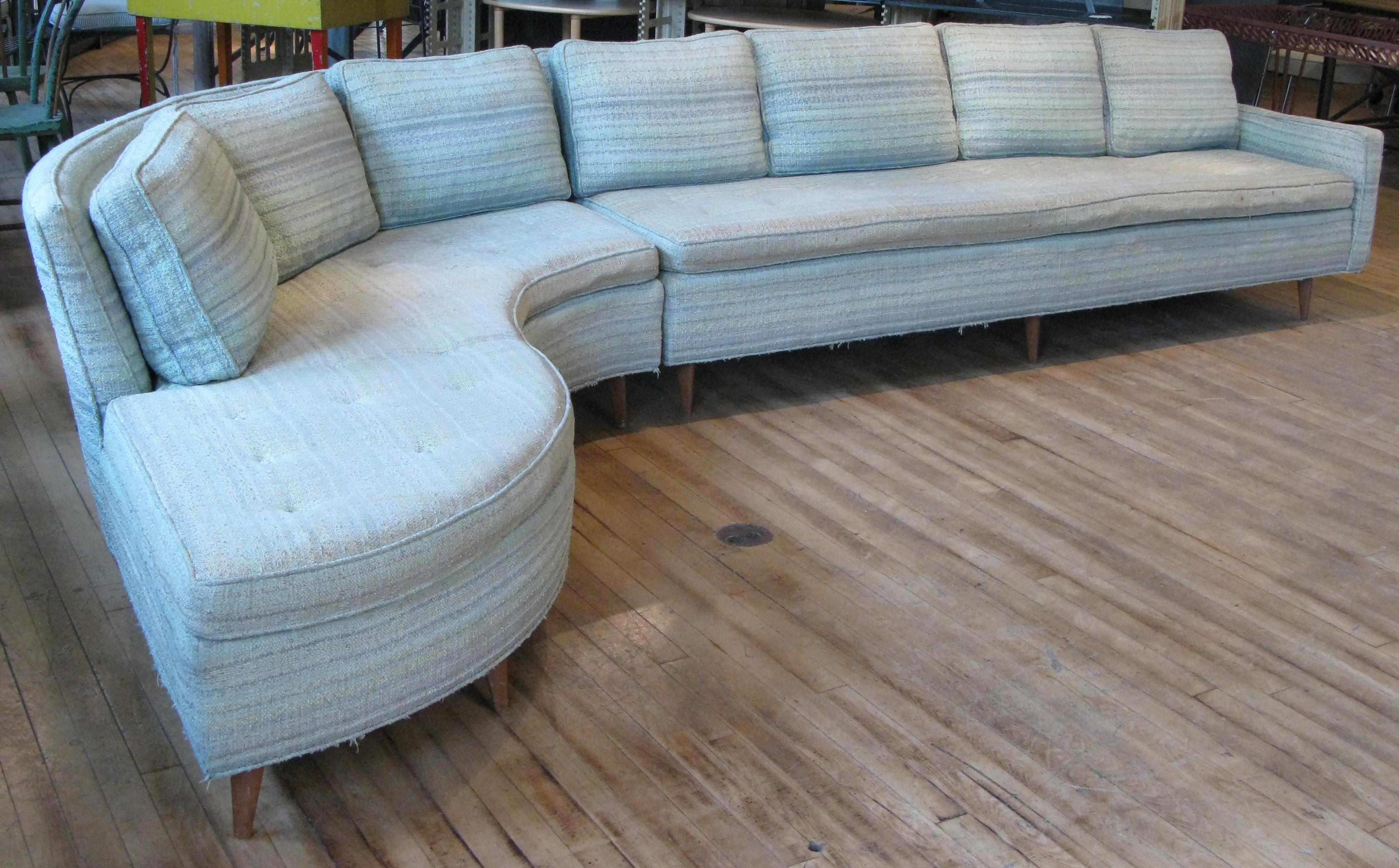 A beautiful and elegant 1950s curved sectional sofa designed by Erwin Lambeth. Composed of a straight section with a single arm, and a curved corner section with and extended seat. Beautiful design and very well made with solid mahogany legs and
