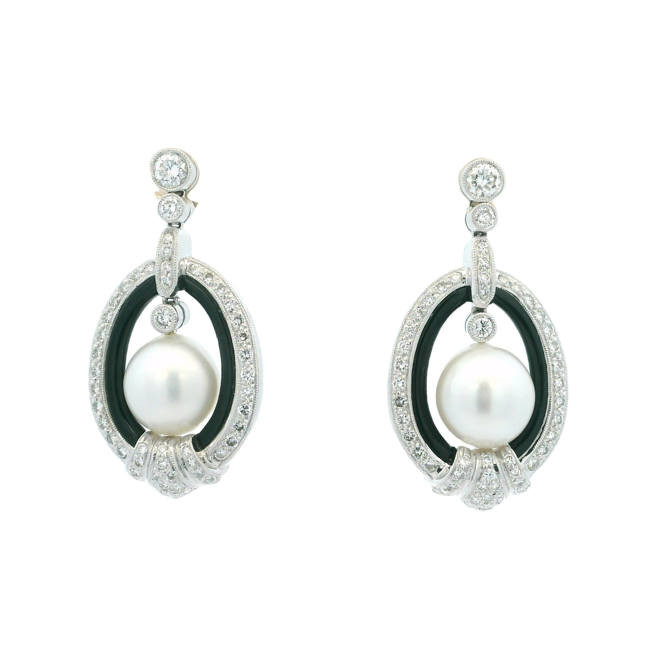 Elevate your fine jewelry collection with these exquisite vintage earrings, showcasing a sophisticated interplay of South Sea pearls, black onyx, and brilliant diamonds. Crafted in 18K white gold and weighing 23.87 grams, these earrings feature