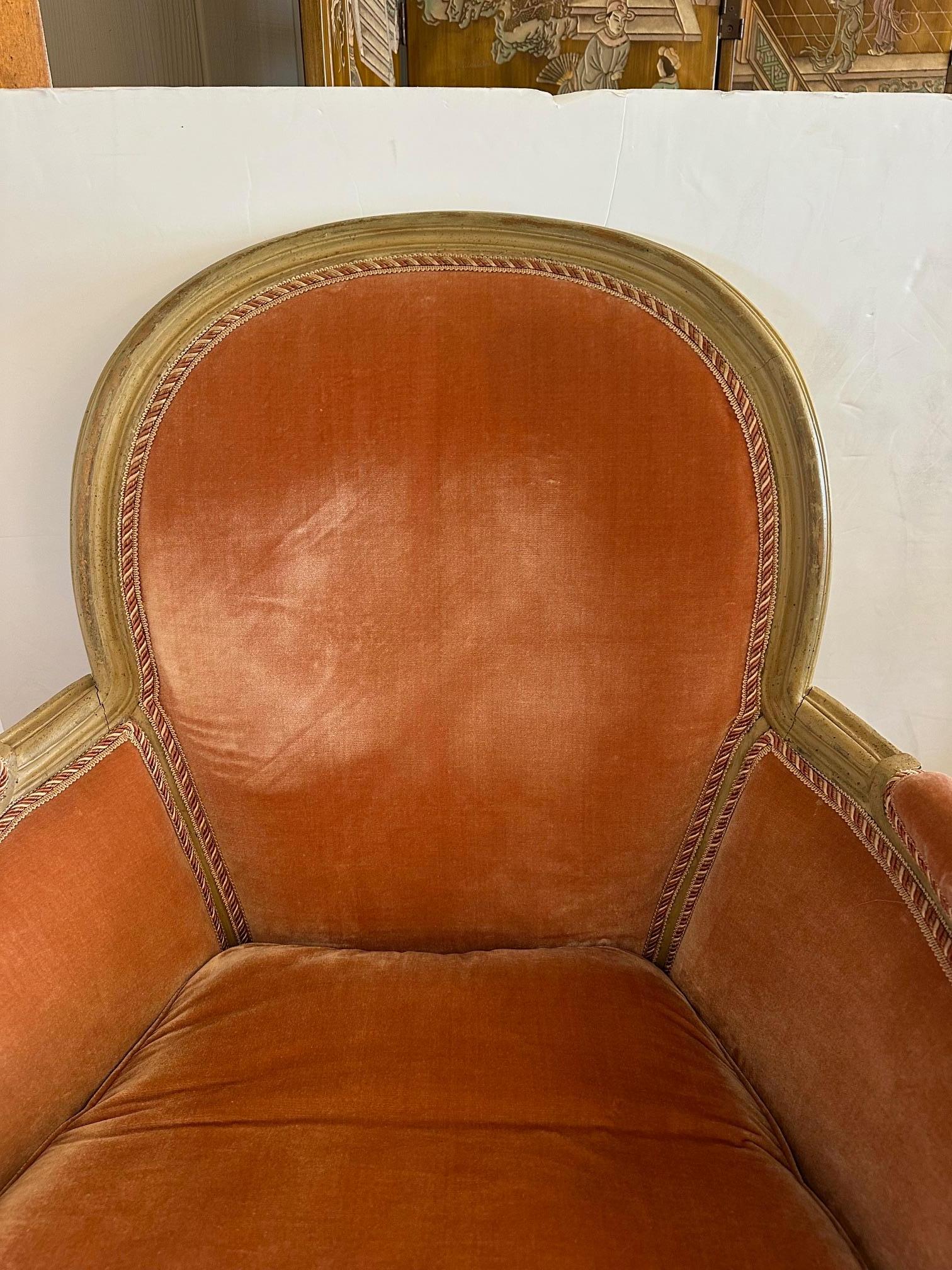 Elegant French style Louis XVI bergere armchair having a luscious apricot velvet upholstery and painted cream colored carved wood frame.
Arm 25” H
Seat 18” H x 20” D
Down cushion