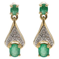 Elegant vintage gold earrings with emeralds and diamonds, mid-20th century.