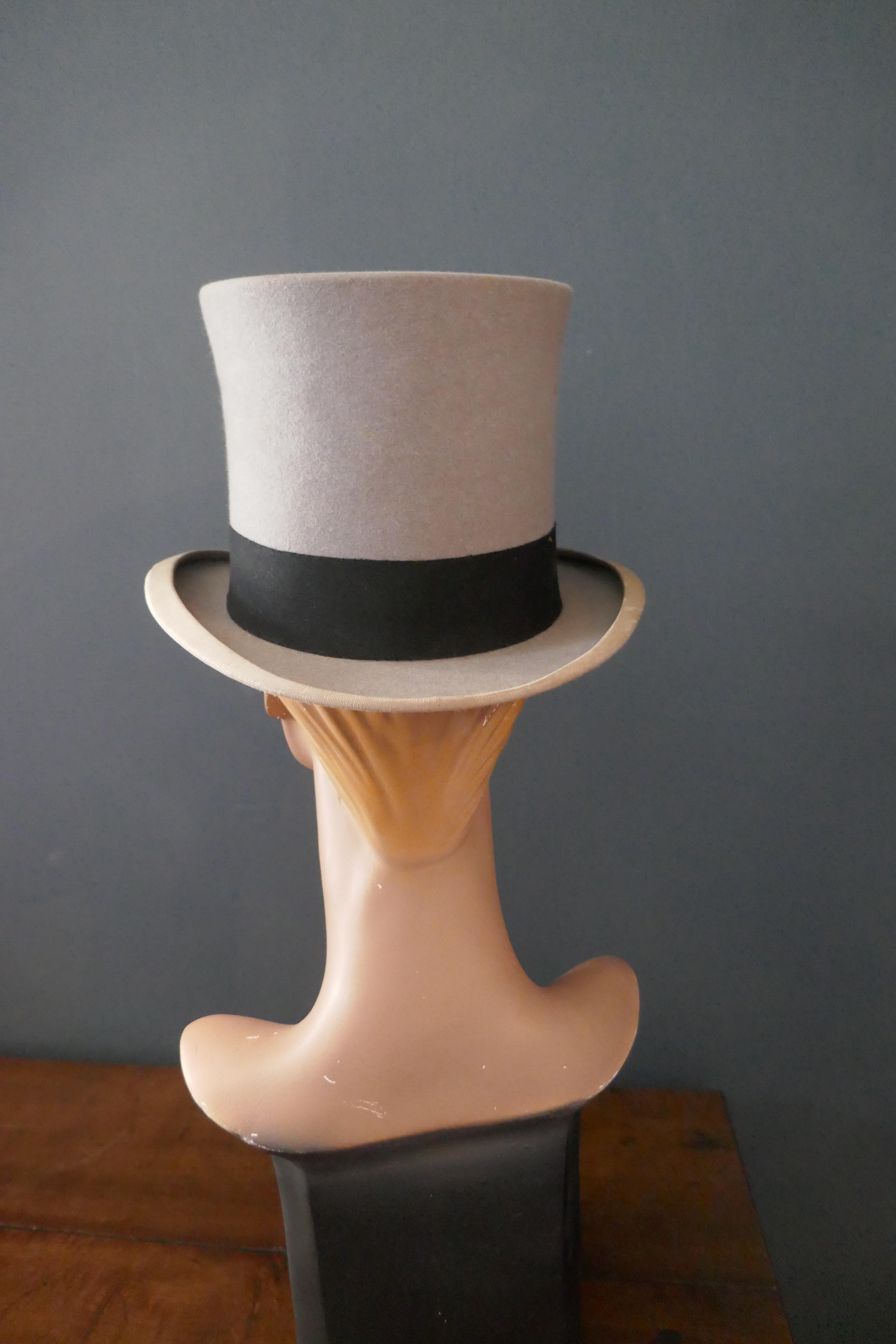 Elegant Vintage Grey Felt Top Hat from Herbert Johnson Bond Street 


Vintage grey felt top hat with black wool band around the brim. 

Kid leather inner band and silk in Lined 

Overall condition is good, some some signs of wear on the brim but no