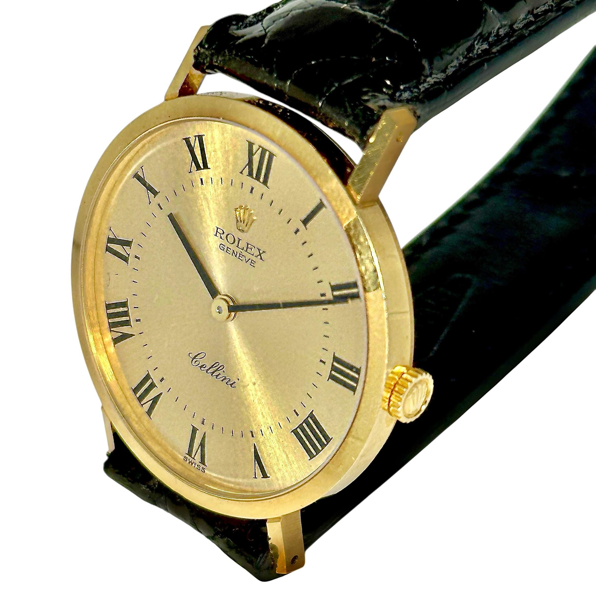 This superlative 18k yellow gold Cellini manual wind dress watch bespeaks refinement and classic elegance. A thirty-two millimeter round case features a matte finish champagne color sunburst pattern dial with gloss black Roman numerals. The