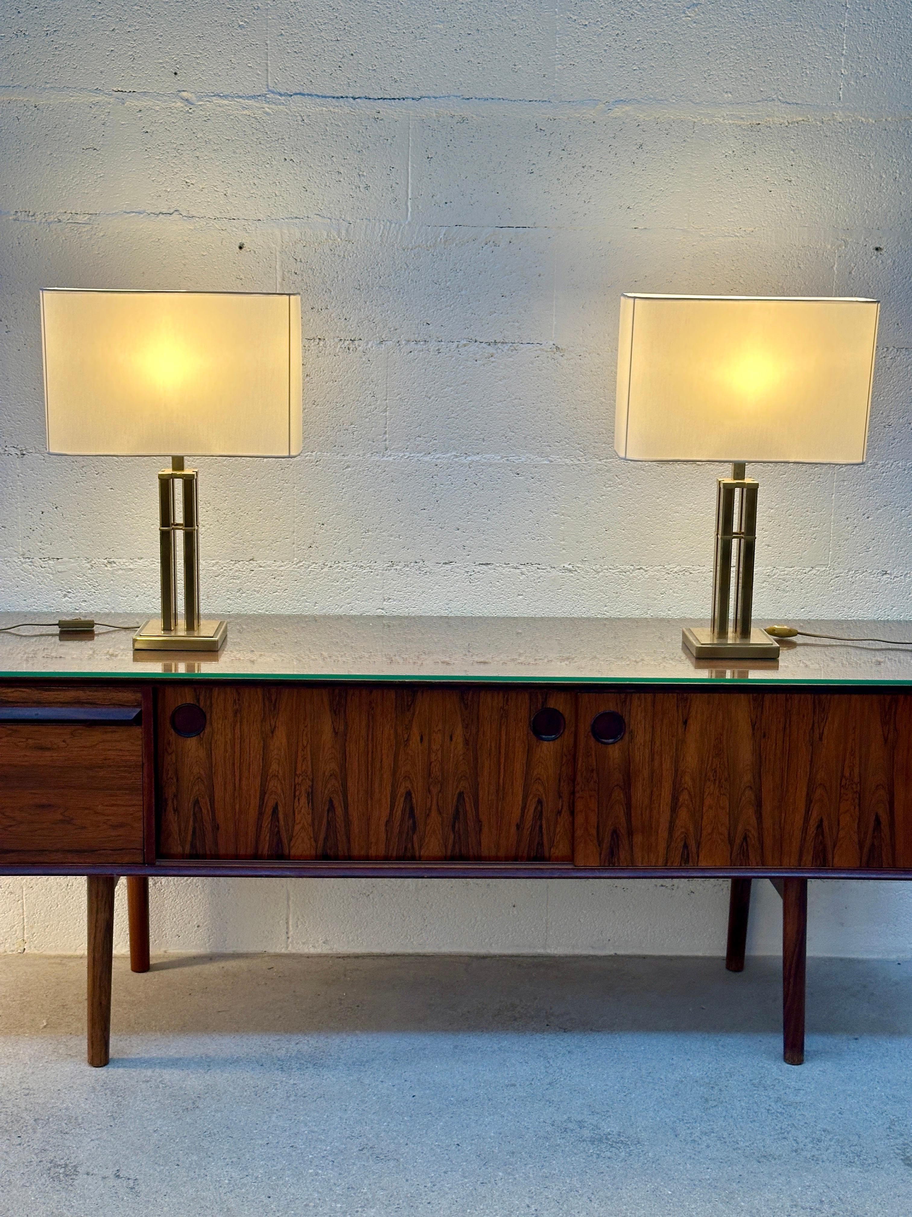 Elegant vintage pair of Romeo Rega-style table lamps, Italy circa 1970s.

Brass base and frame signed JJS. The lampshades are original, and the fabric has been redone.

One standard E27 bulb per lamp. Compatible with LED bulbs.

Lampshade: