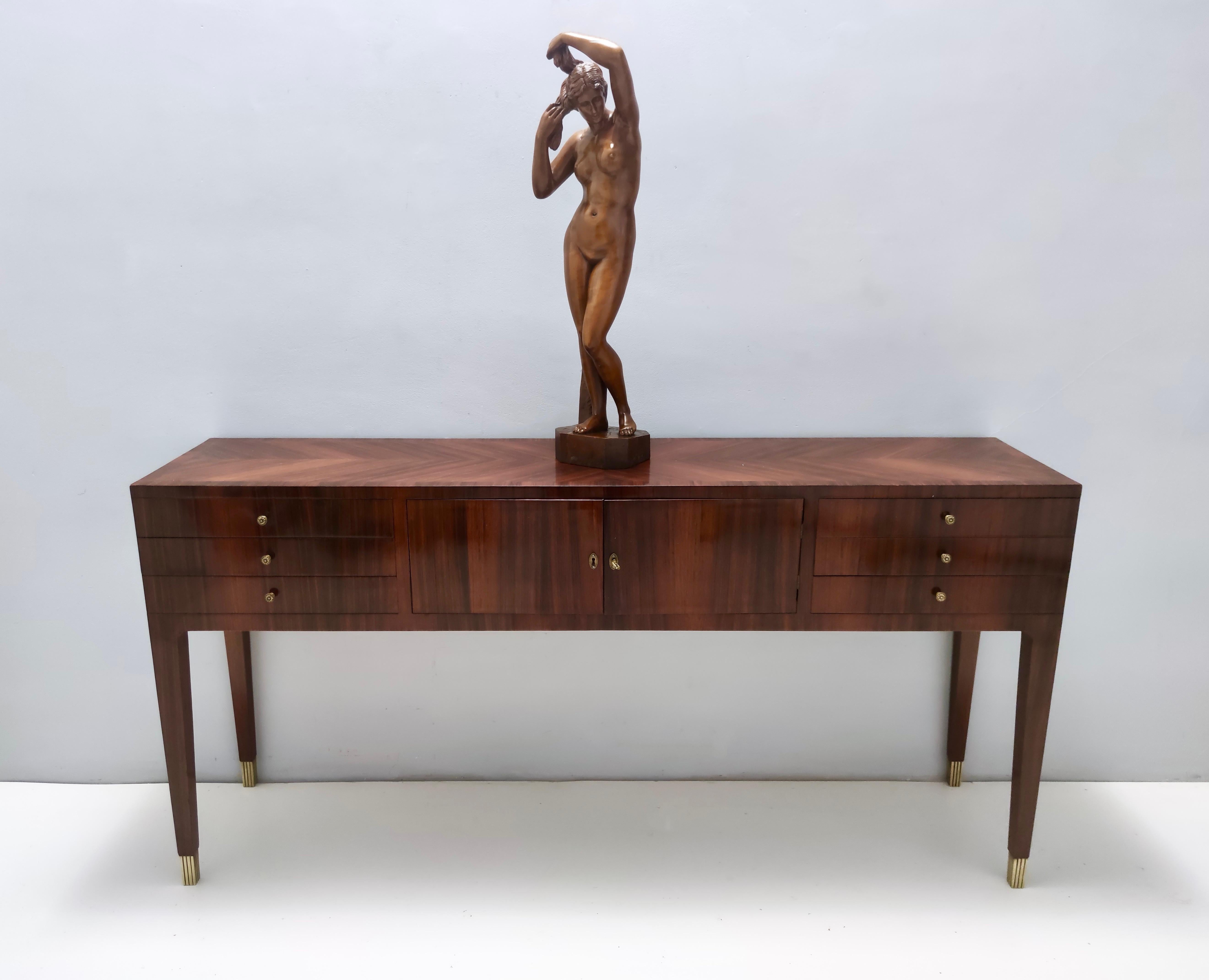 Made in Italy in the 60s in Cantù, a city in Lombardy which is well-known for their talented wood artisans.
This is an incredible high-quality classicist piece, realized in solid walnut blocks to avoid cracks.
It's been hand-polished.
It is a