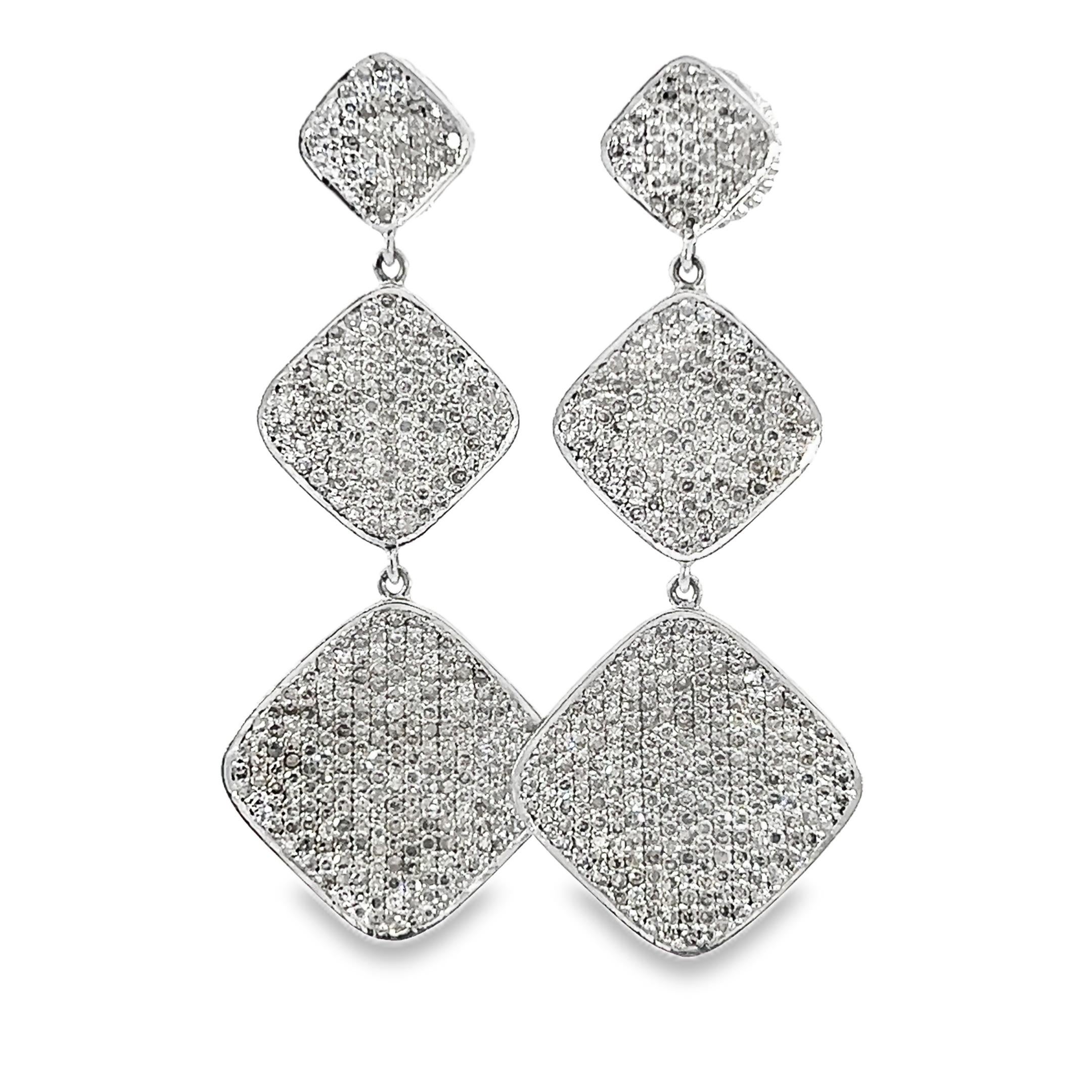 These stunning 14-Kt white gold 3.95-Carat diamond earrings are the perfect accessory for any occasion. Their unique design features a series of shimmering diamond-shaped elements that catch the light beautifully, adding a touch of elegance to your